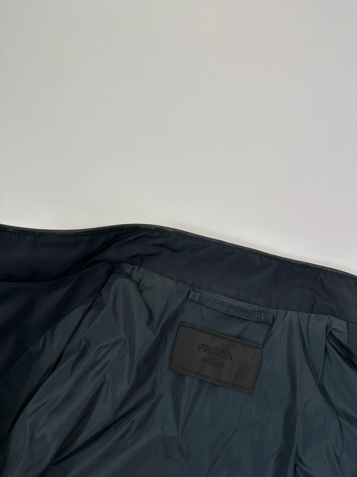 Prada bomber jacket navy blue nylon with reinforced details and minimalist design.