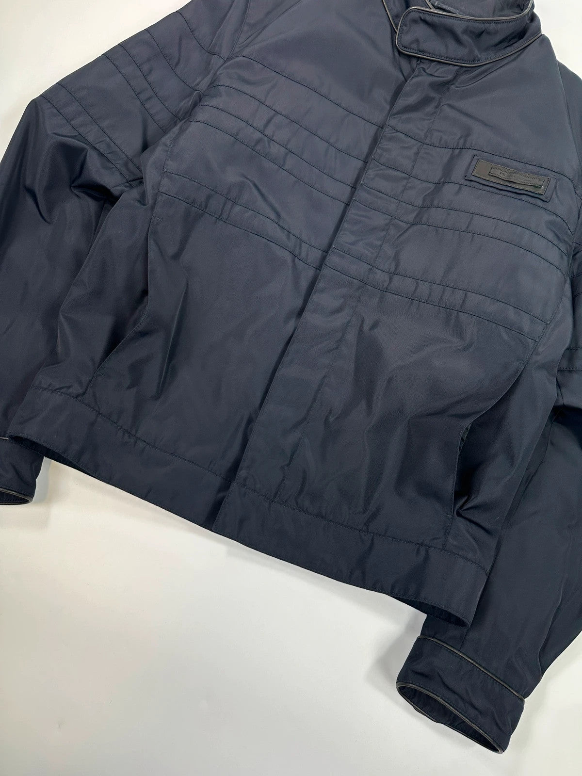 Prada bomber jacket navy blue nylon with reinforced details and minimalist design.