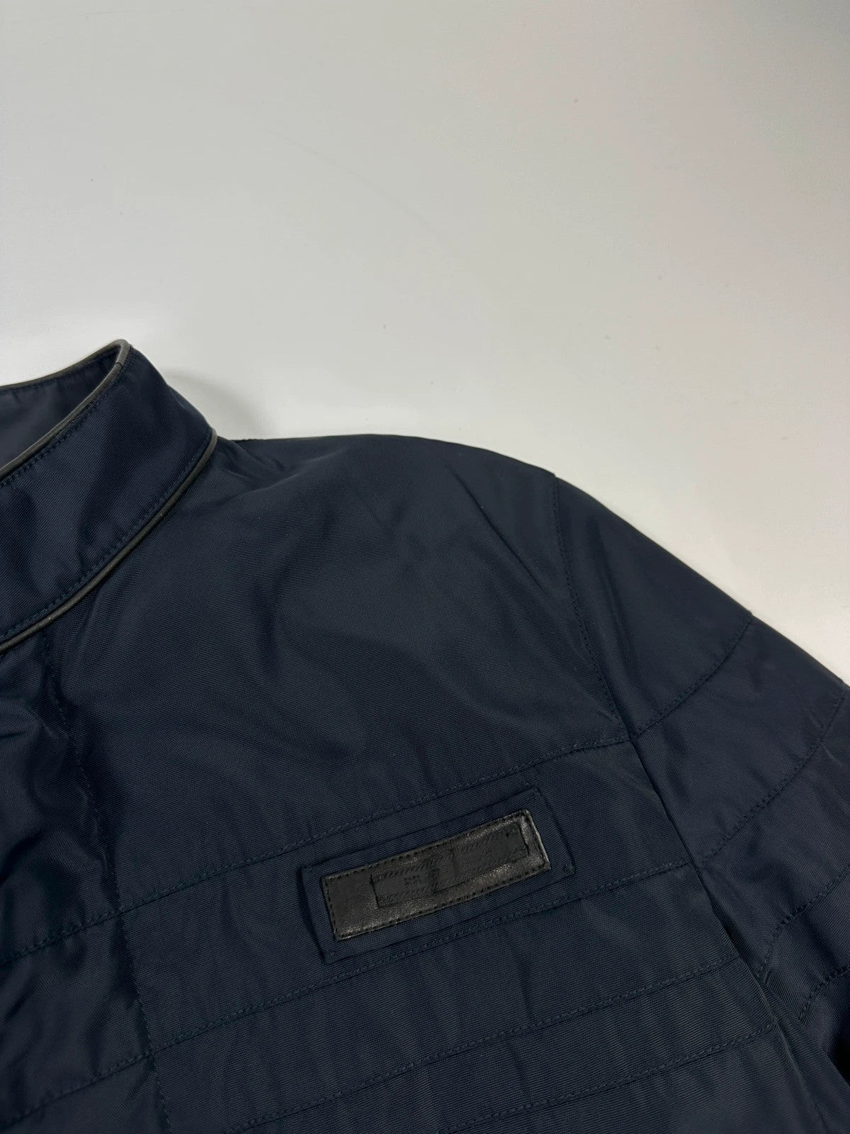 Prada bomber jacket navy blue nylon with reinforced details and minimalist design.