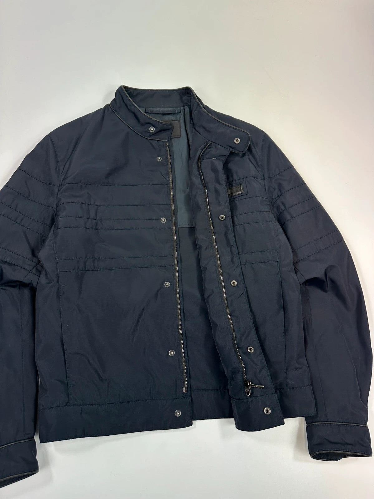 Prada bomber jacket navy blue nylon with reinforced details and minimalist design.