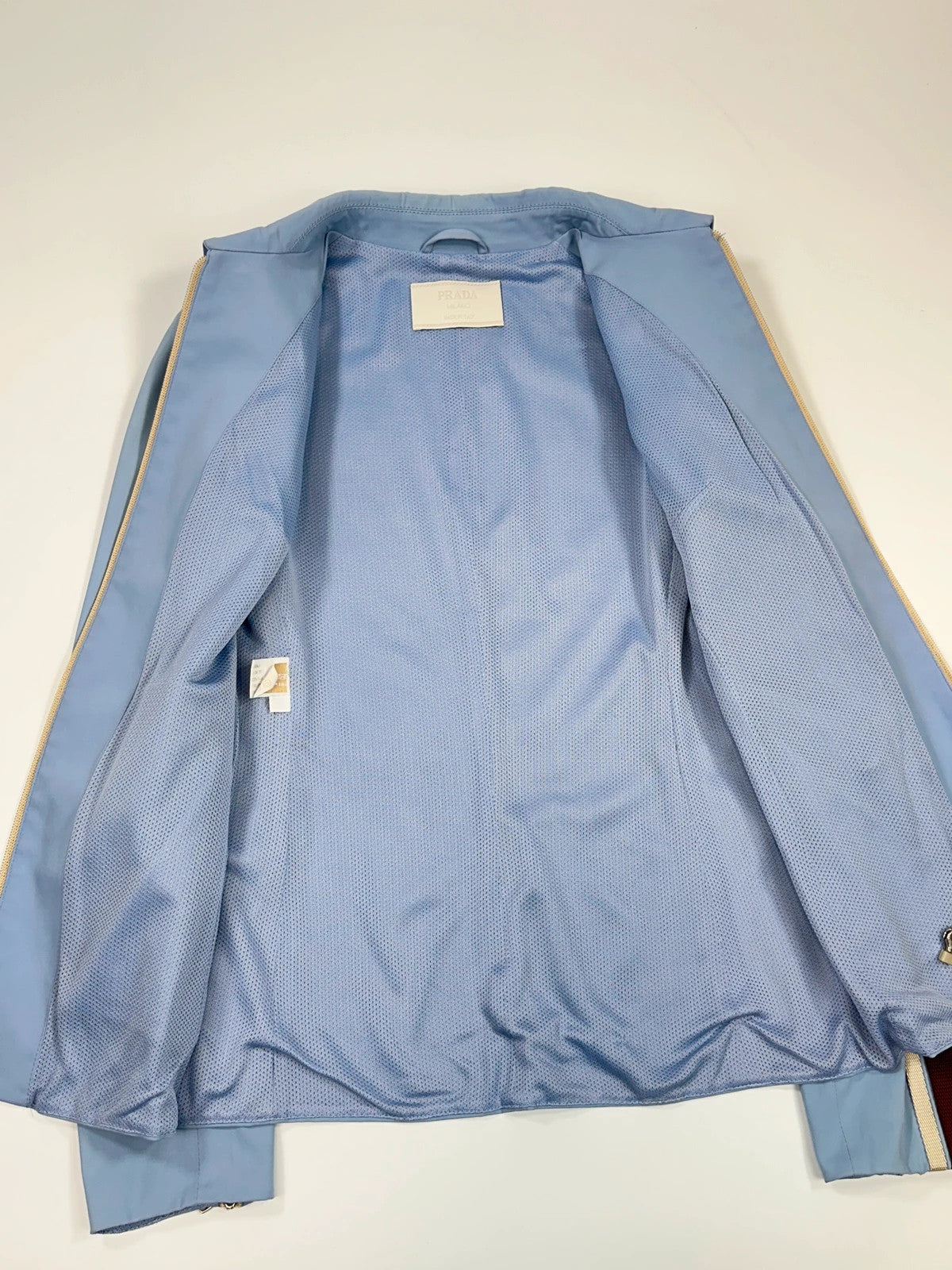 Prada blue striped jacket in nylon and silk with logo detailing.