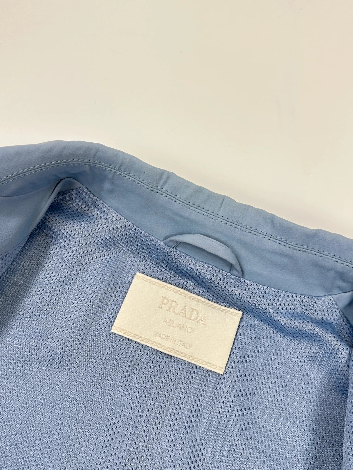 Prada blue striped jacket in nylon and silk with logo detailing.