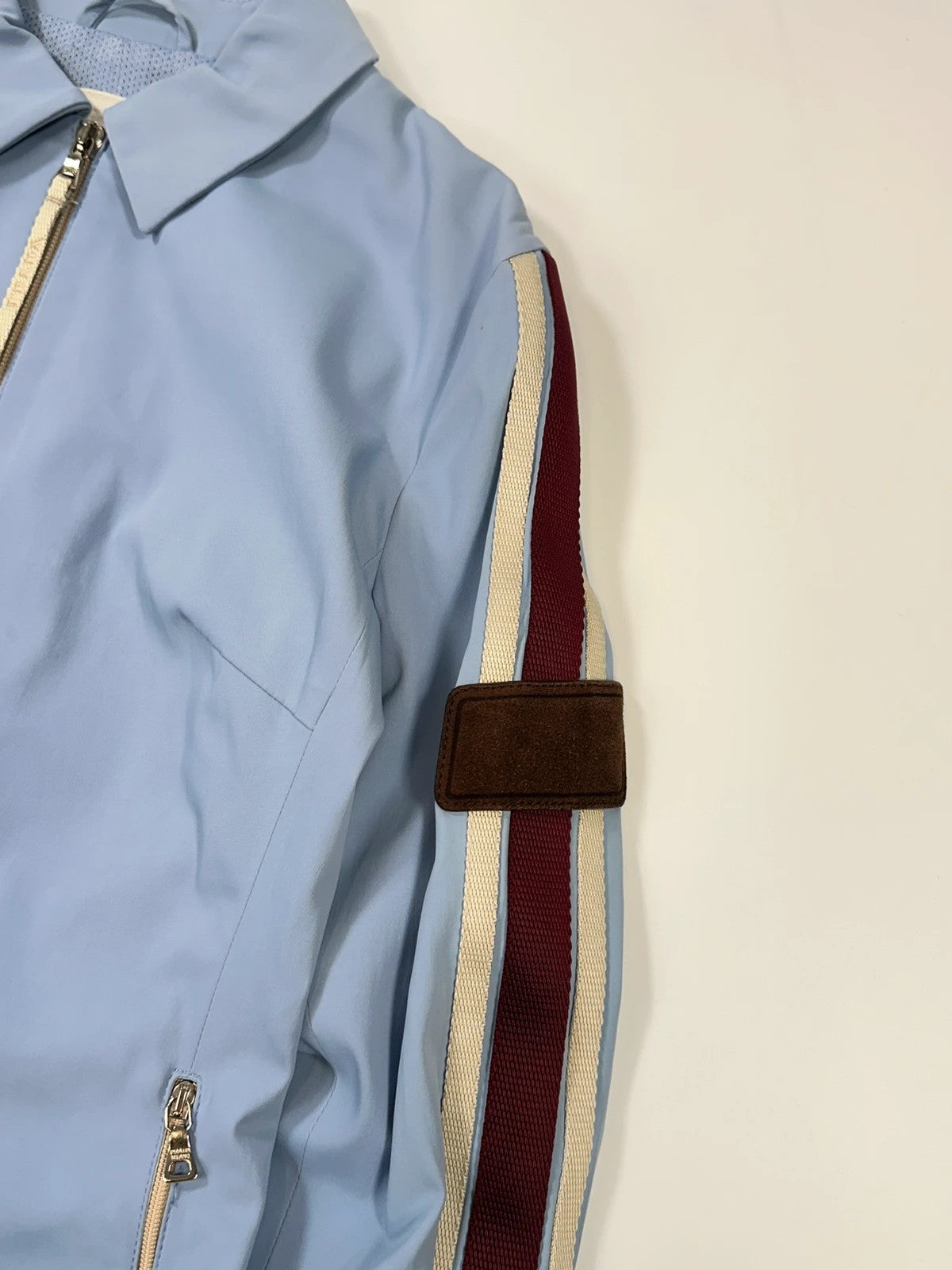 Prada blue striped jacket in nylon and silk with logo detailing.