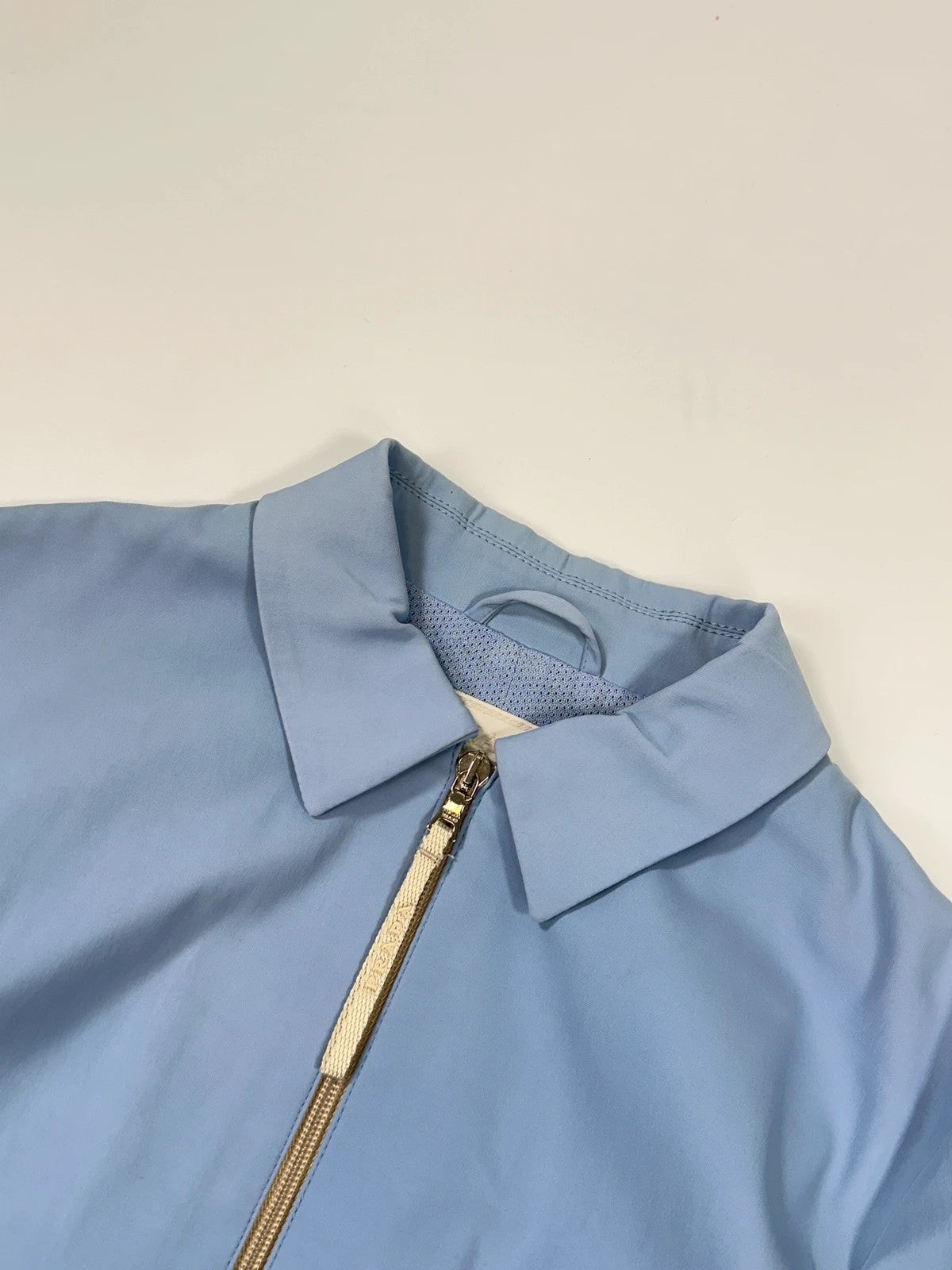 Prada blue striped jacket in nylon and silk with logo detailing.