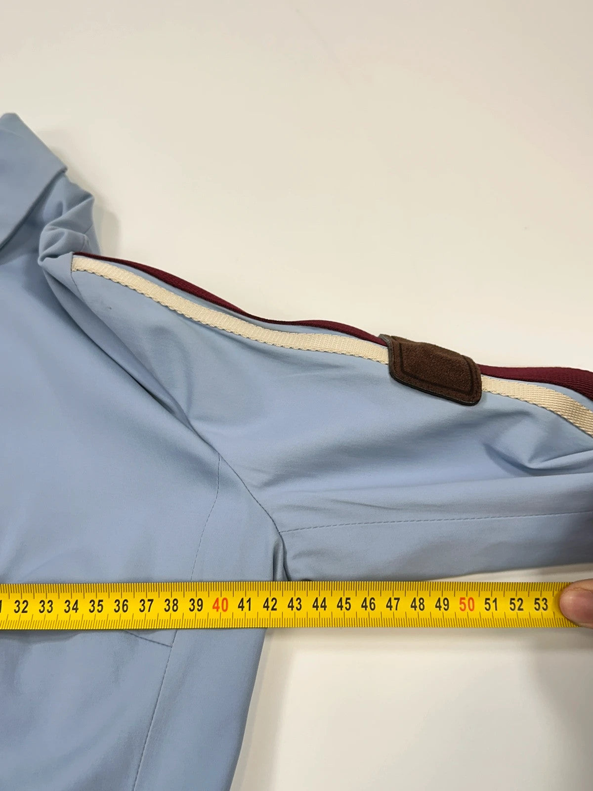 Prada blue striped jacket in nylon and silk with logo detailing.