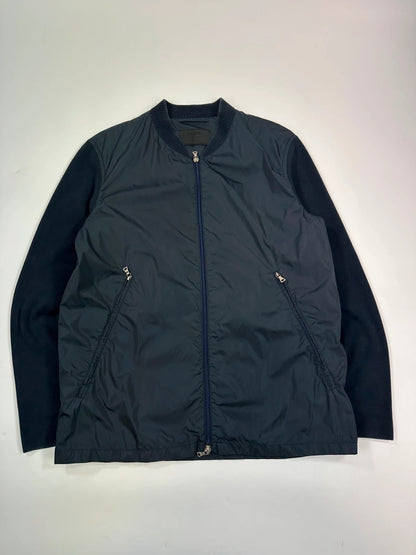 Prada navy blue hybrid jacket with nylon front and cotton sleeves, minimalist design.
