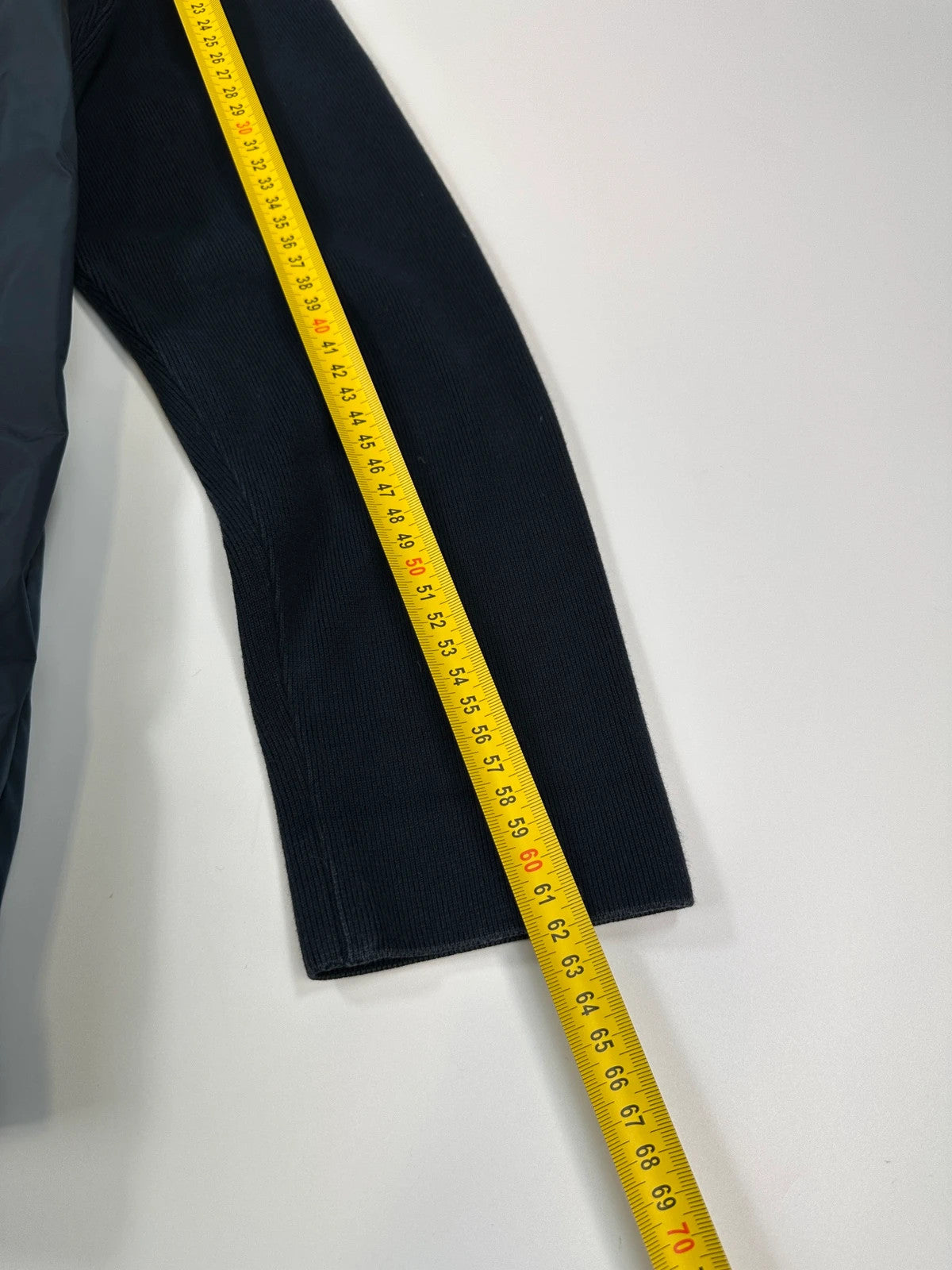 Prada navy blue hybrid jacket with nylon front and cotton sleeves, minimalist design.