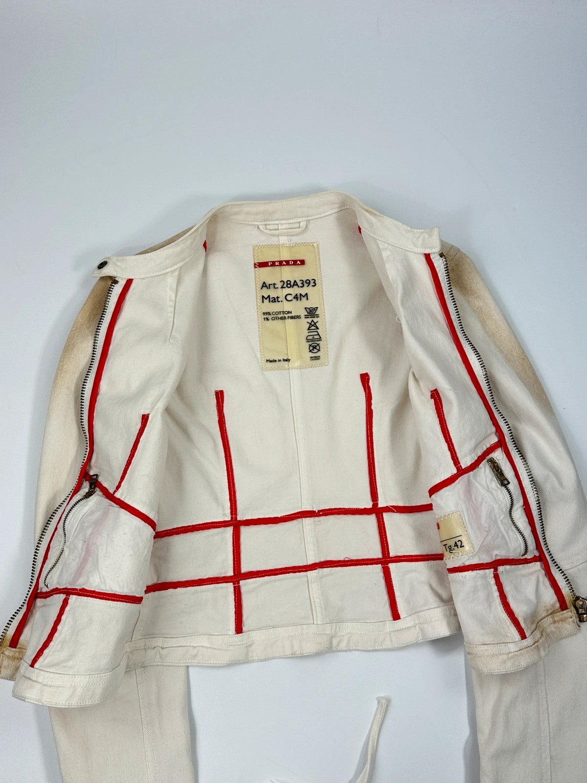 Prada brown and white denim jacket with lace detailing and faded wash effect.