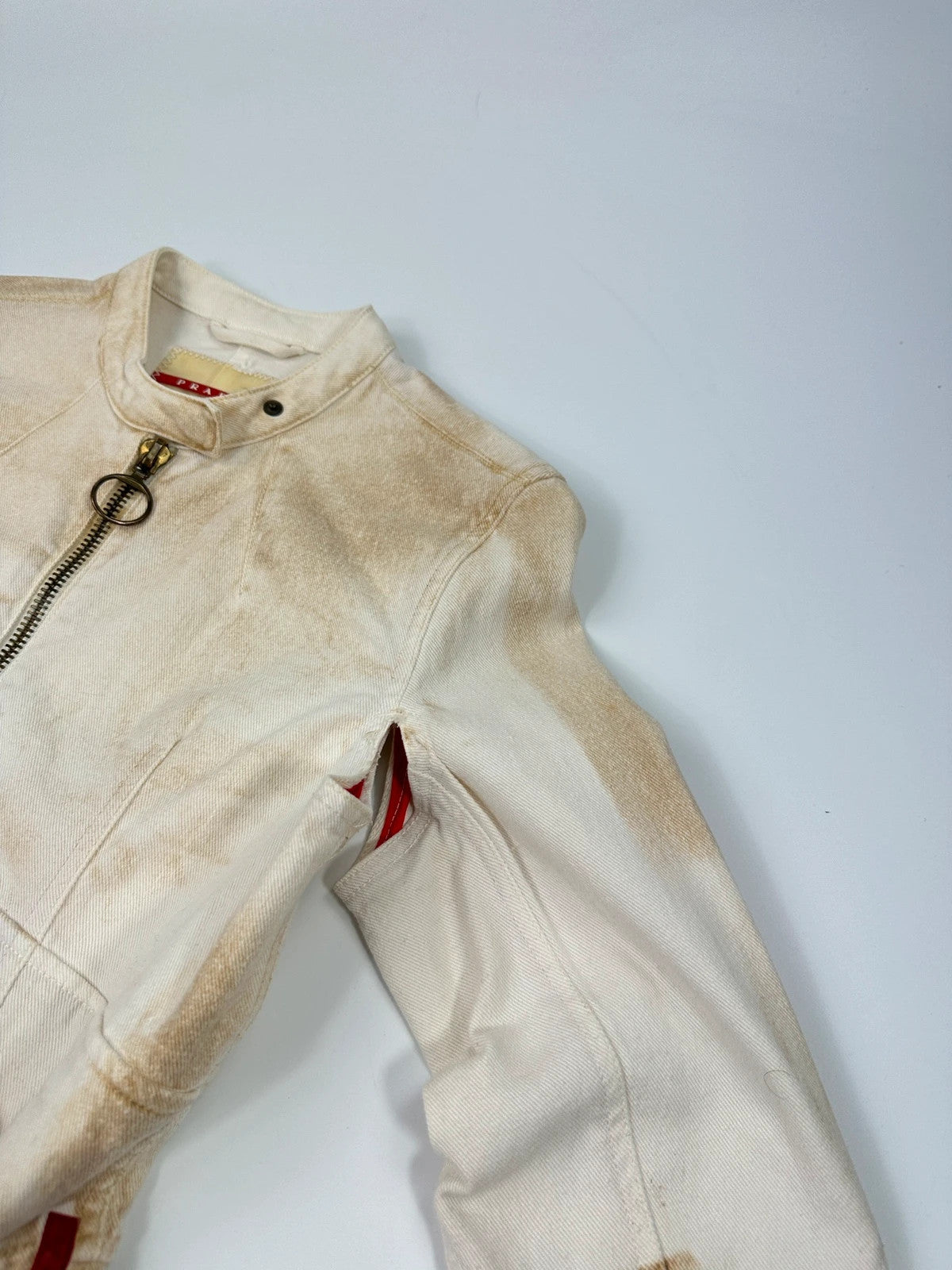 Prada brown and white denim jacket with lace detailing and faded wash effect.