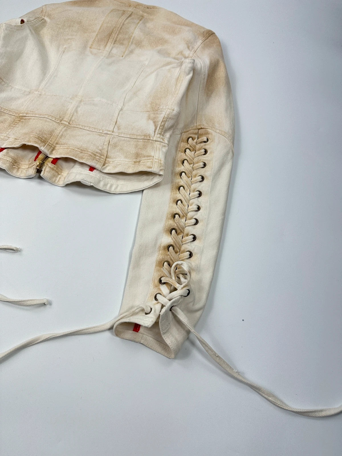 Prada brown and white denim jacket with lace detailing and faded wash effect.