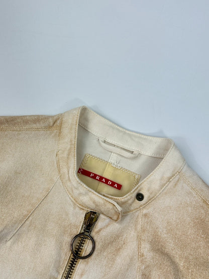 Prada brown and white denim jacket with lace detailing and faded wash effect.