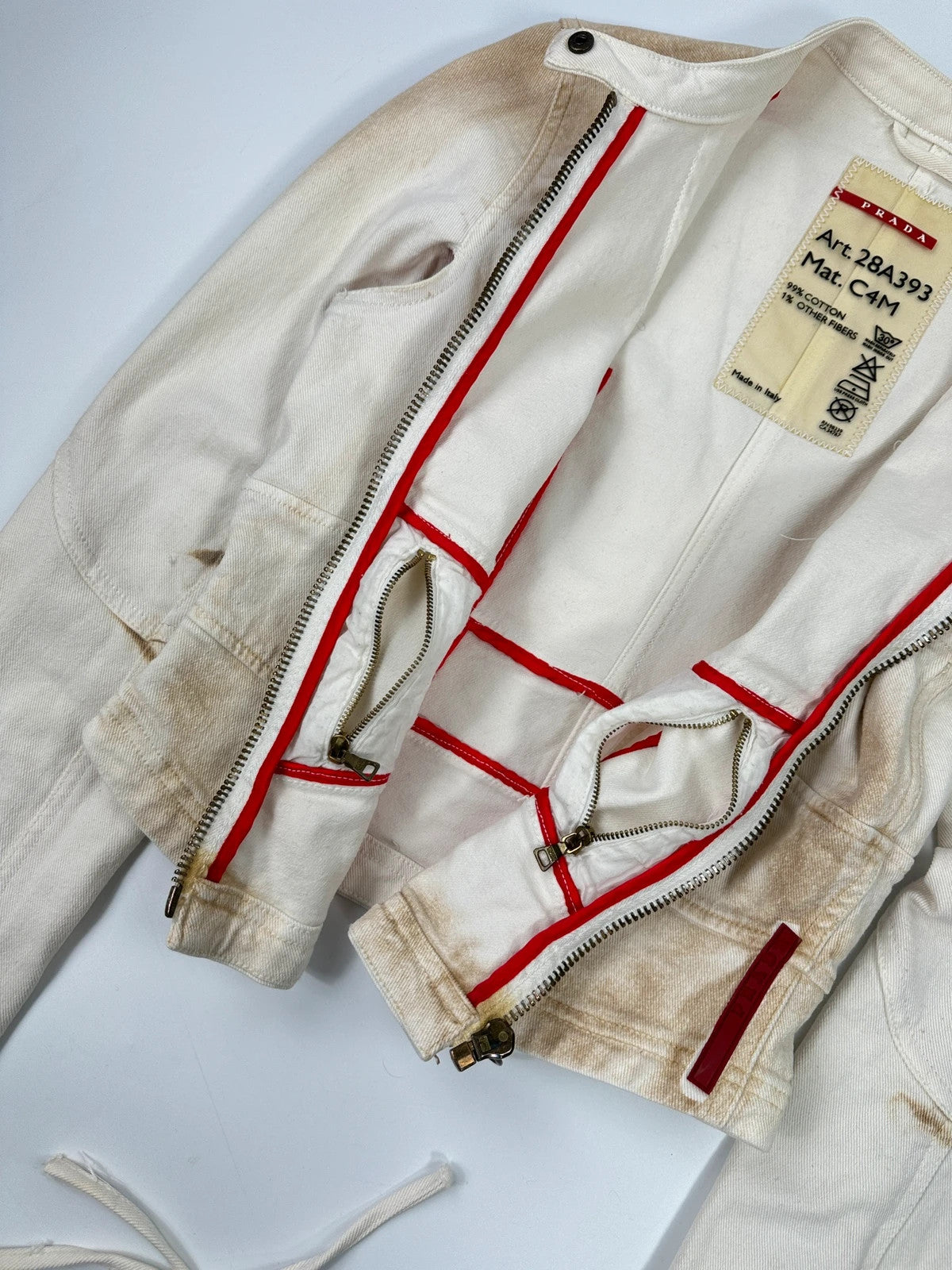 Prada brown and white denim jacket with lace detailing and faded wash effect.