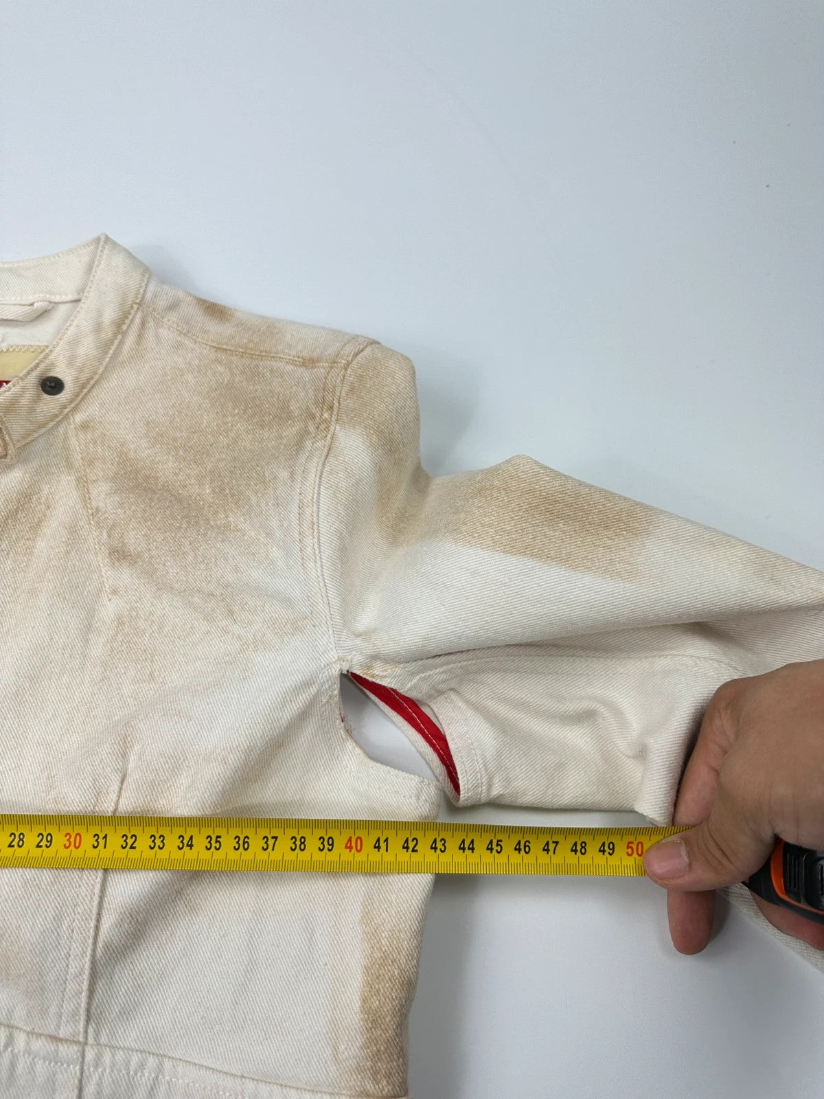 Prada brown and white denim jacket with lace detailing and faded wash effect.