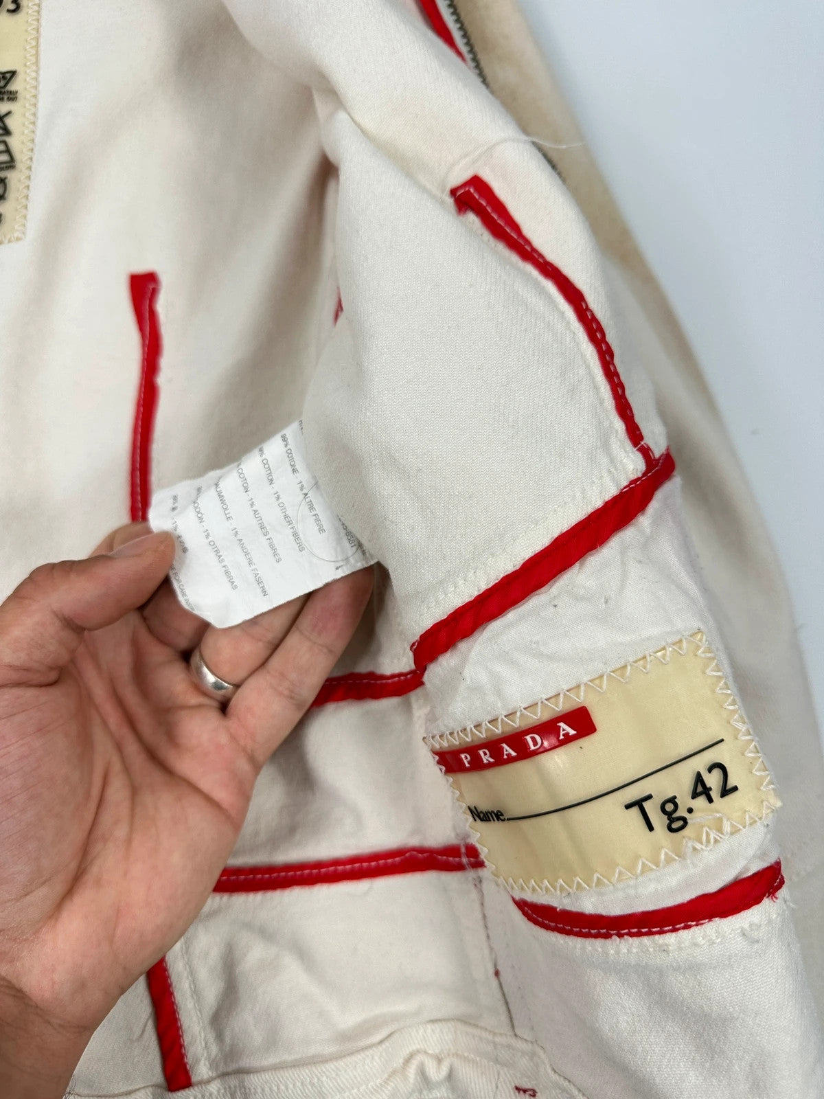 Prada brown and white denim jacket with lace detailing and faded wash effect.