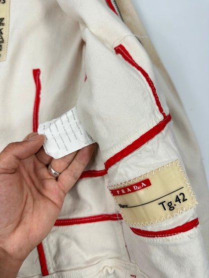 Prada brown and white denim jacket with lace detailing and faded wash effect.