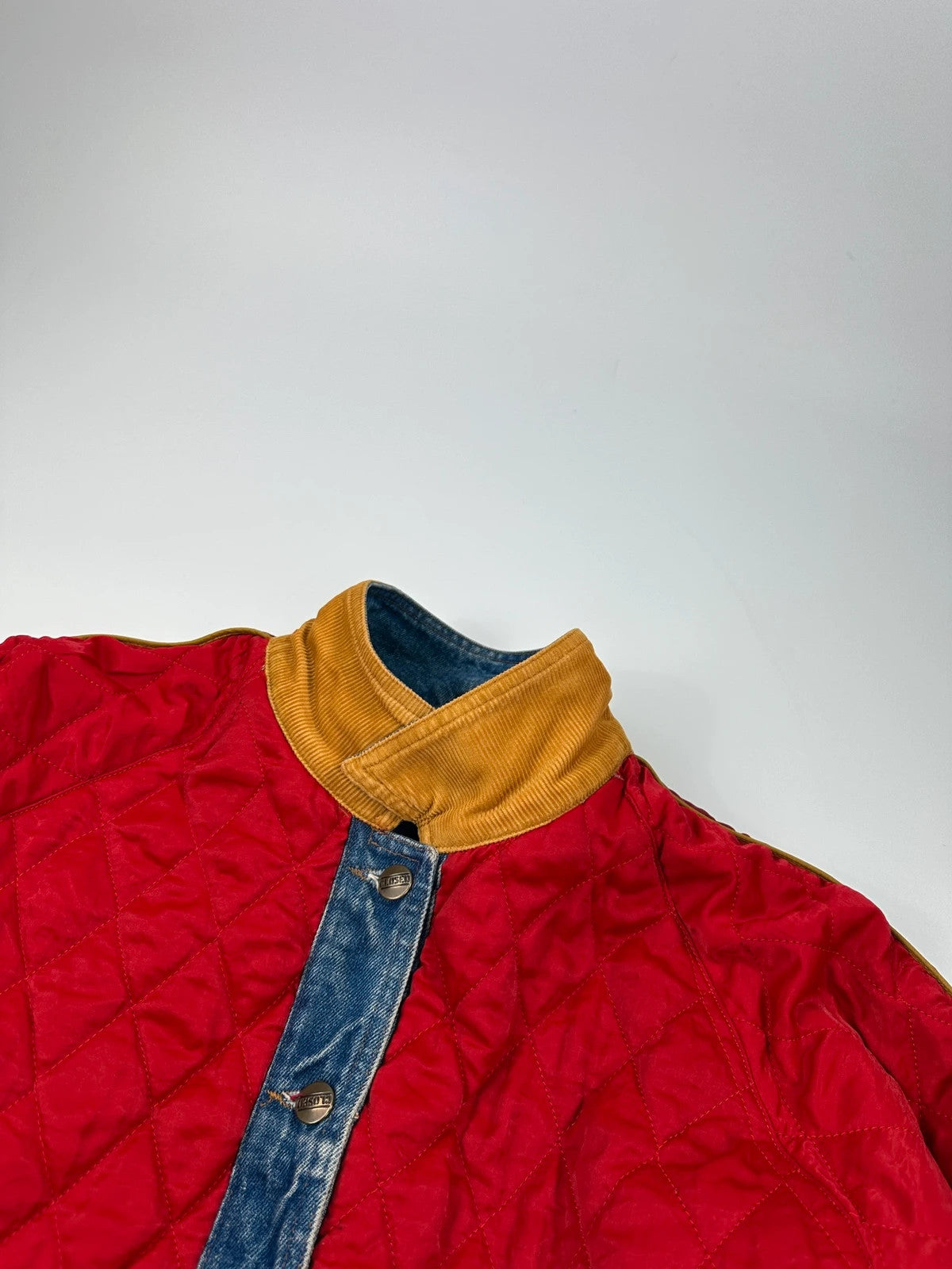 Marithé François Girbaud blue and red reversible denim bomber jacket with logo details.