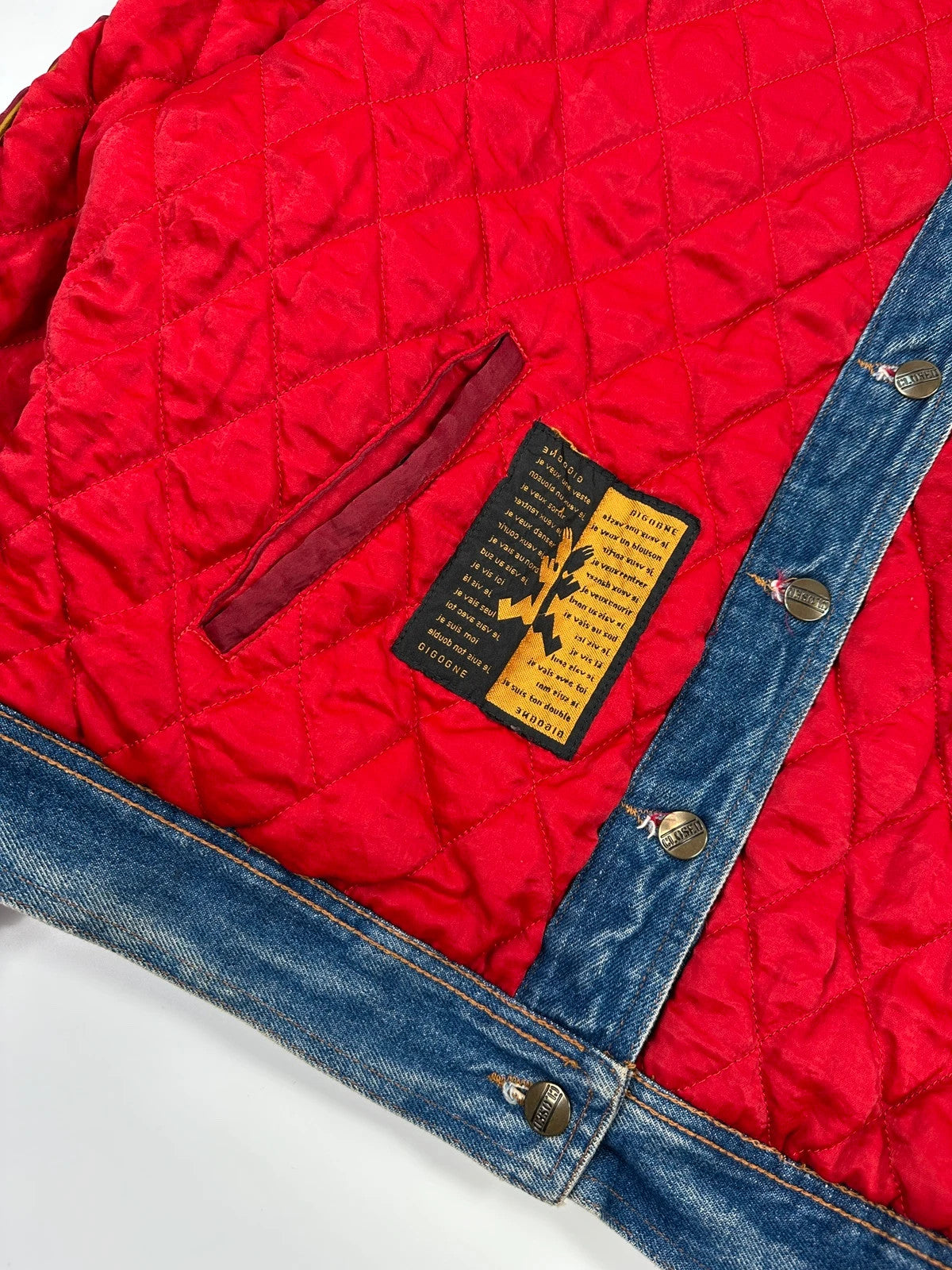 Marithé François Girbaud blue and red reversible denim bomber jacket with logo details.