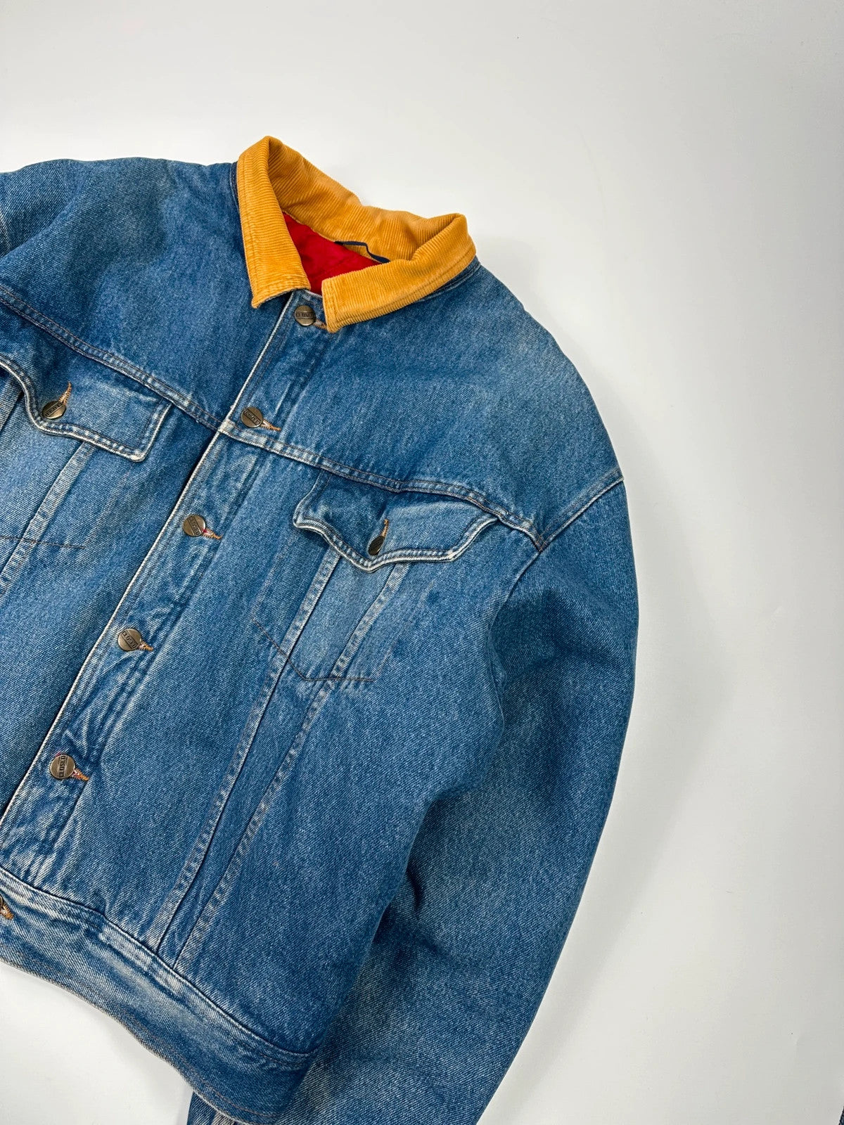 Marithé François Girbaud blue and red reversible denim bomber jacket with logo details.