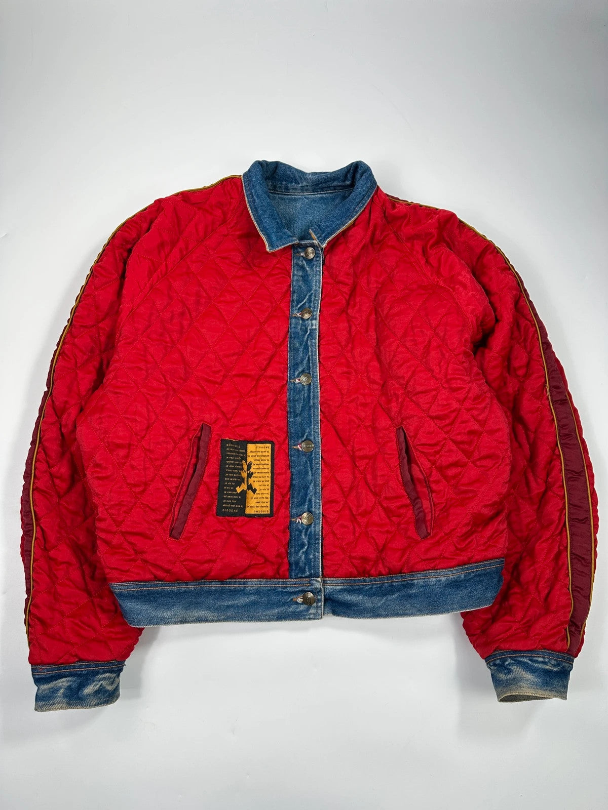 Marithé François Girbaud blue and red reversible denim bomber jacket with logo details.
