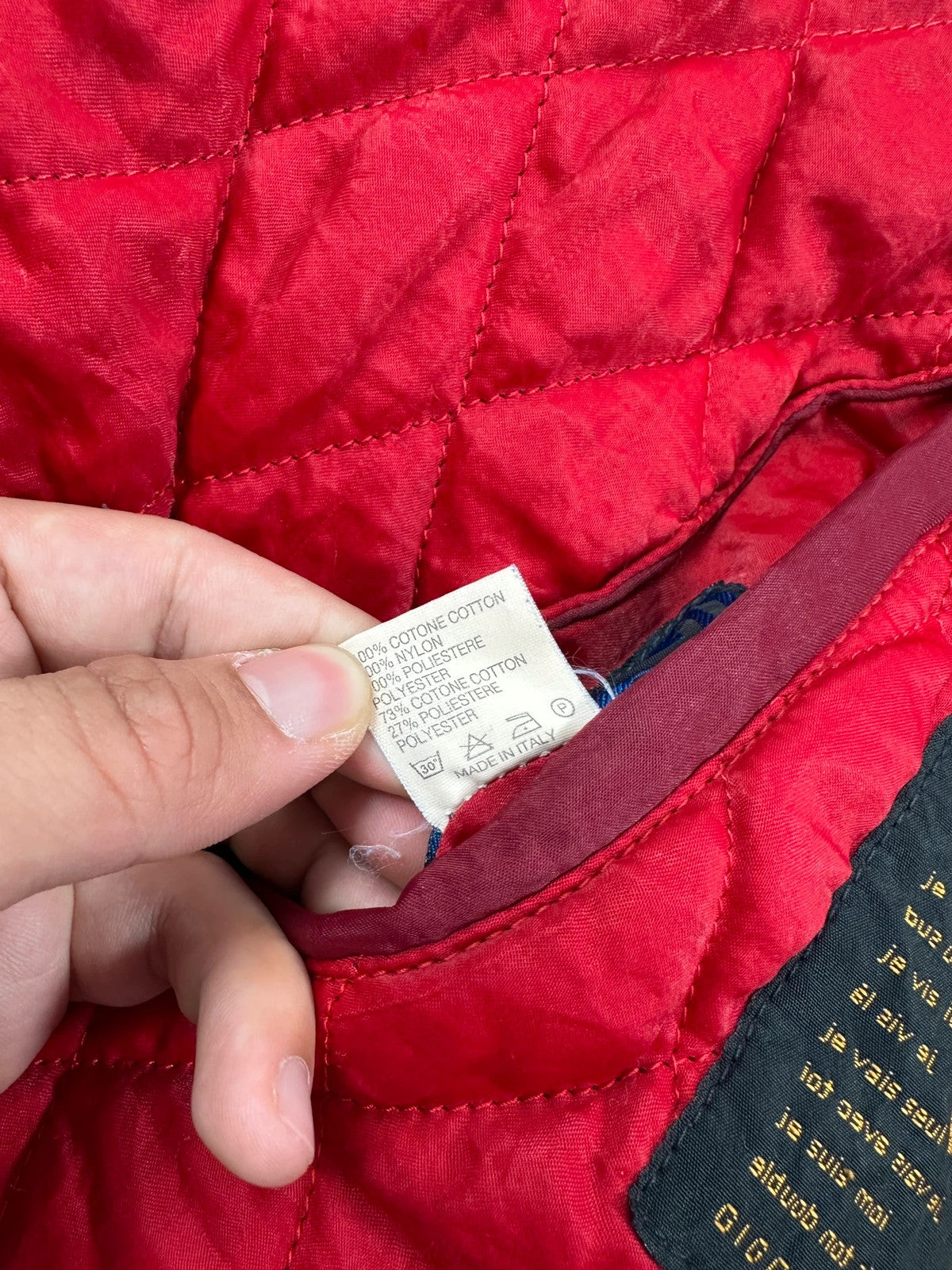 Marithé François Girbaud blue and red reversible denim bomber jacket with logo details.
