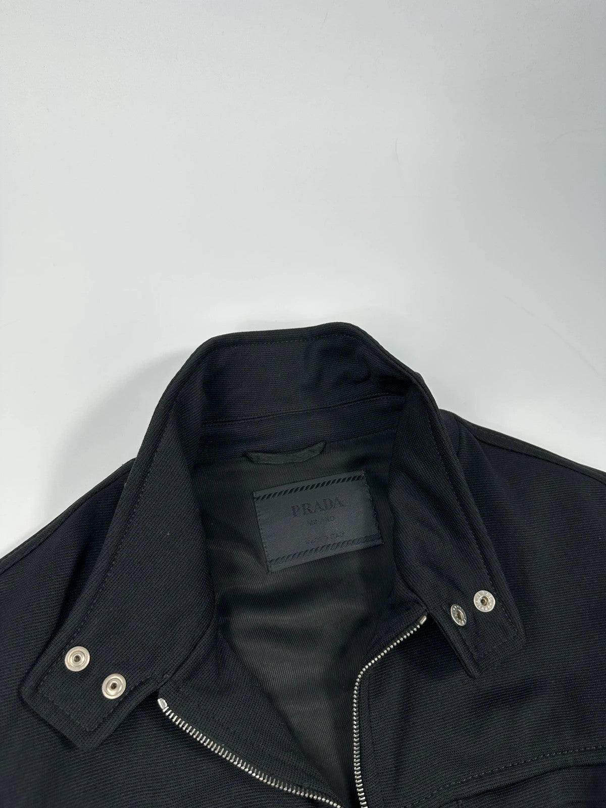Prada black nylon Harrington bomber jacket with padded lining and vintage logo details.