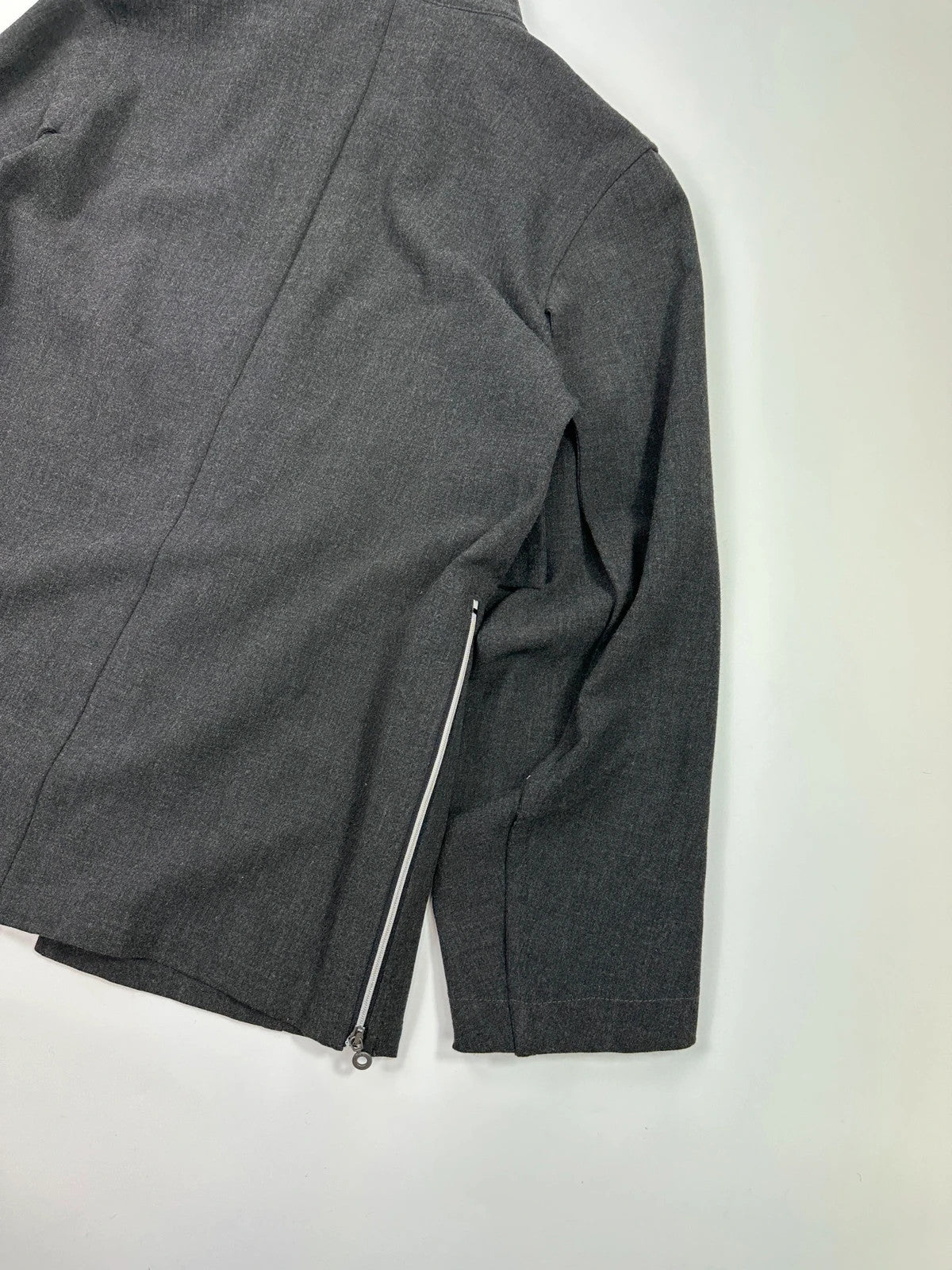 Marithé François Girbaud grey tech jacket with side zippers and minimalist design.