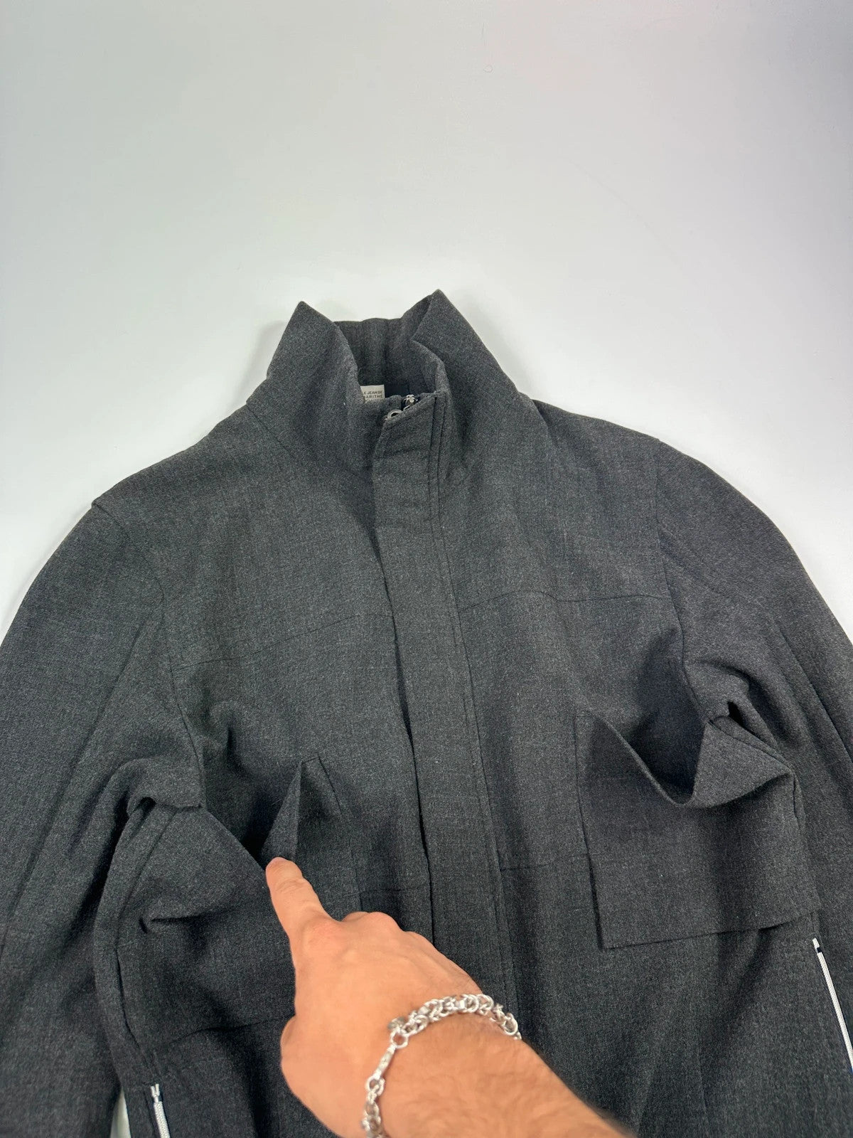 Marithé François Girbaud grey tech jacket with side zippers and minimalist design.