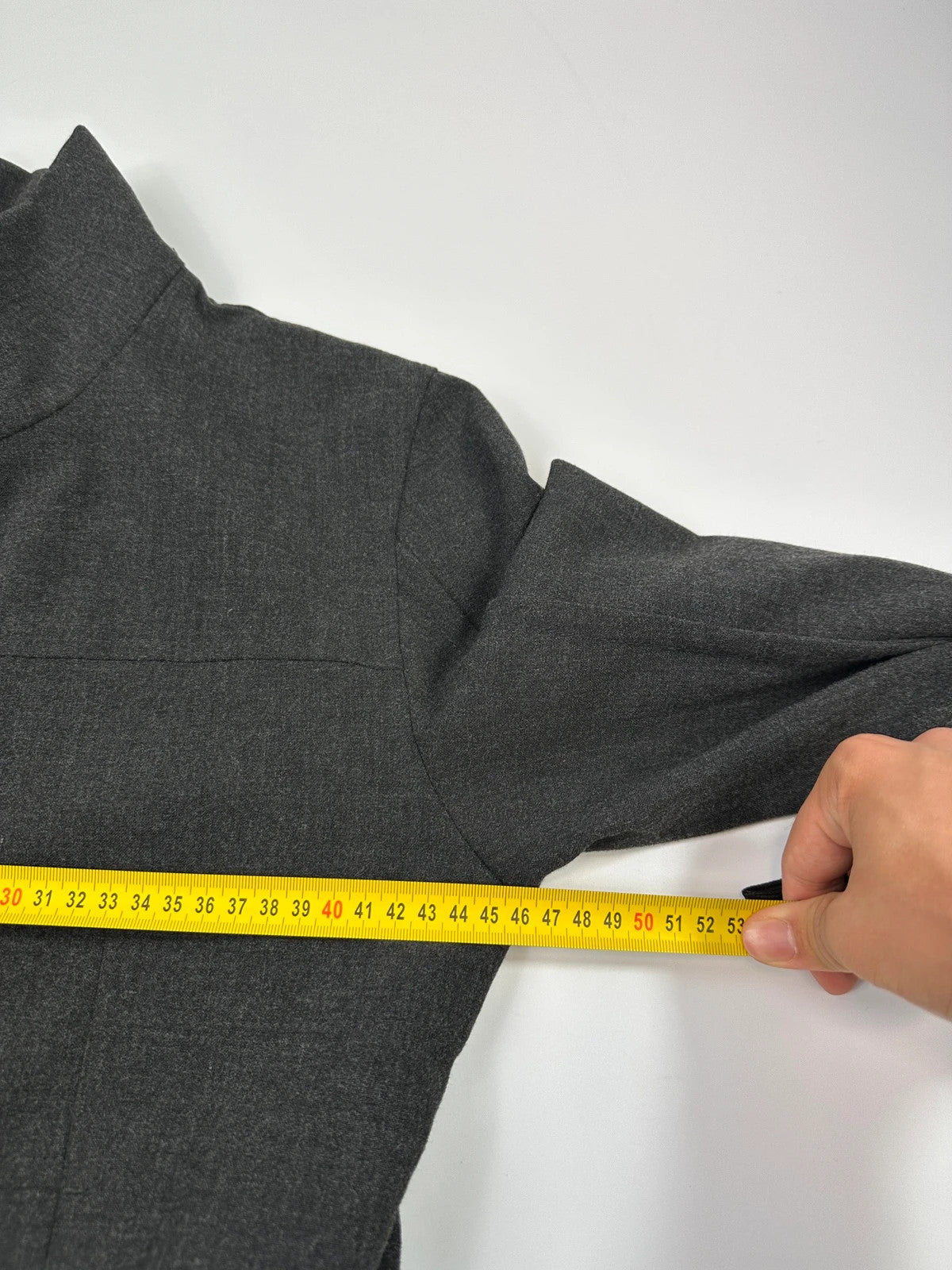 Marithé François Girbaud grey tech jacket with side zippers and minimalist design.