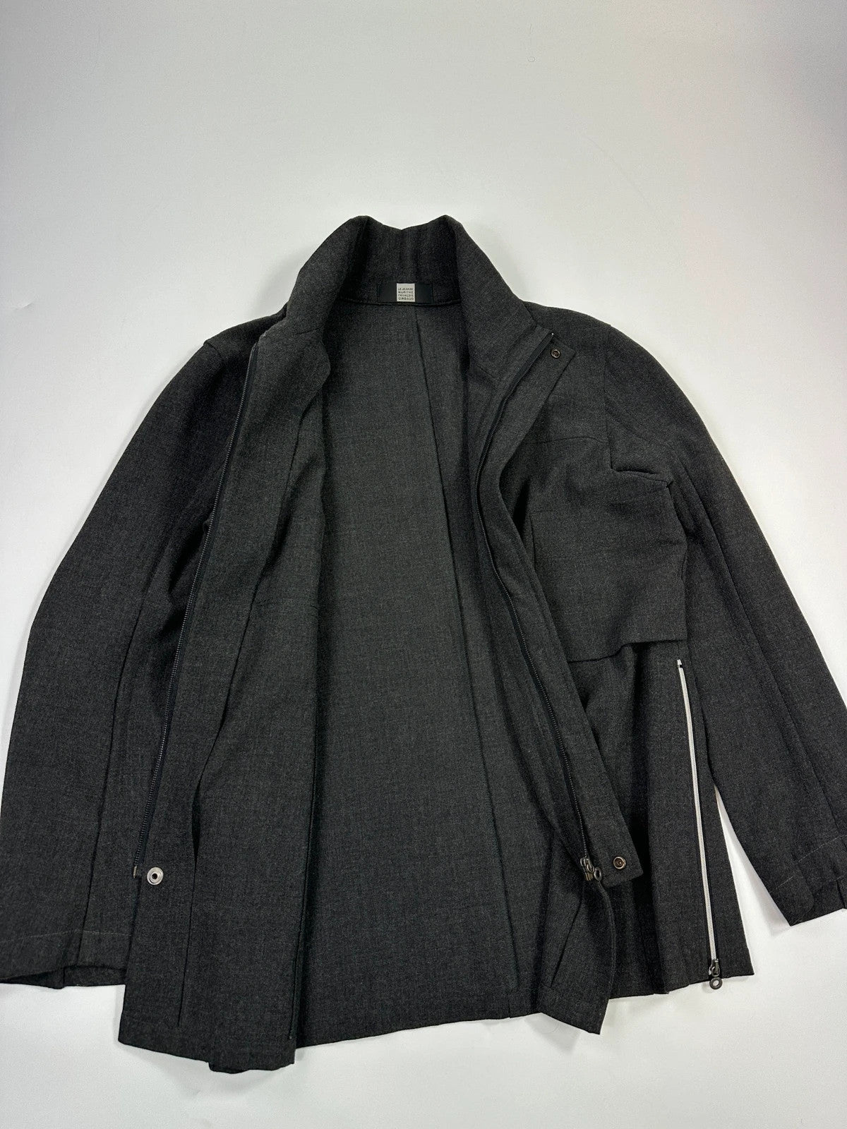 Marithé François Girbaud grey tech jacket with side zippers and minimalist design.