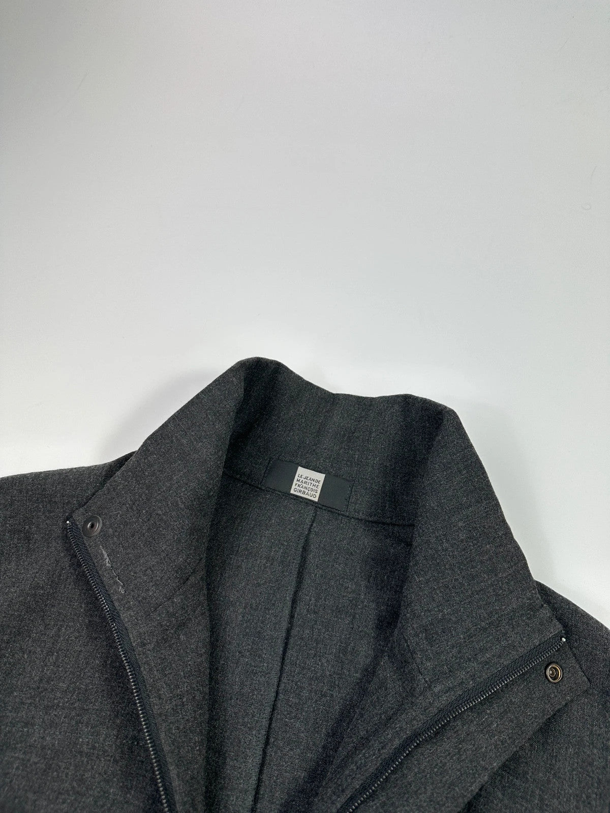 Marithé François Girbaud grey tech jacket with side zippers and minimalist design.