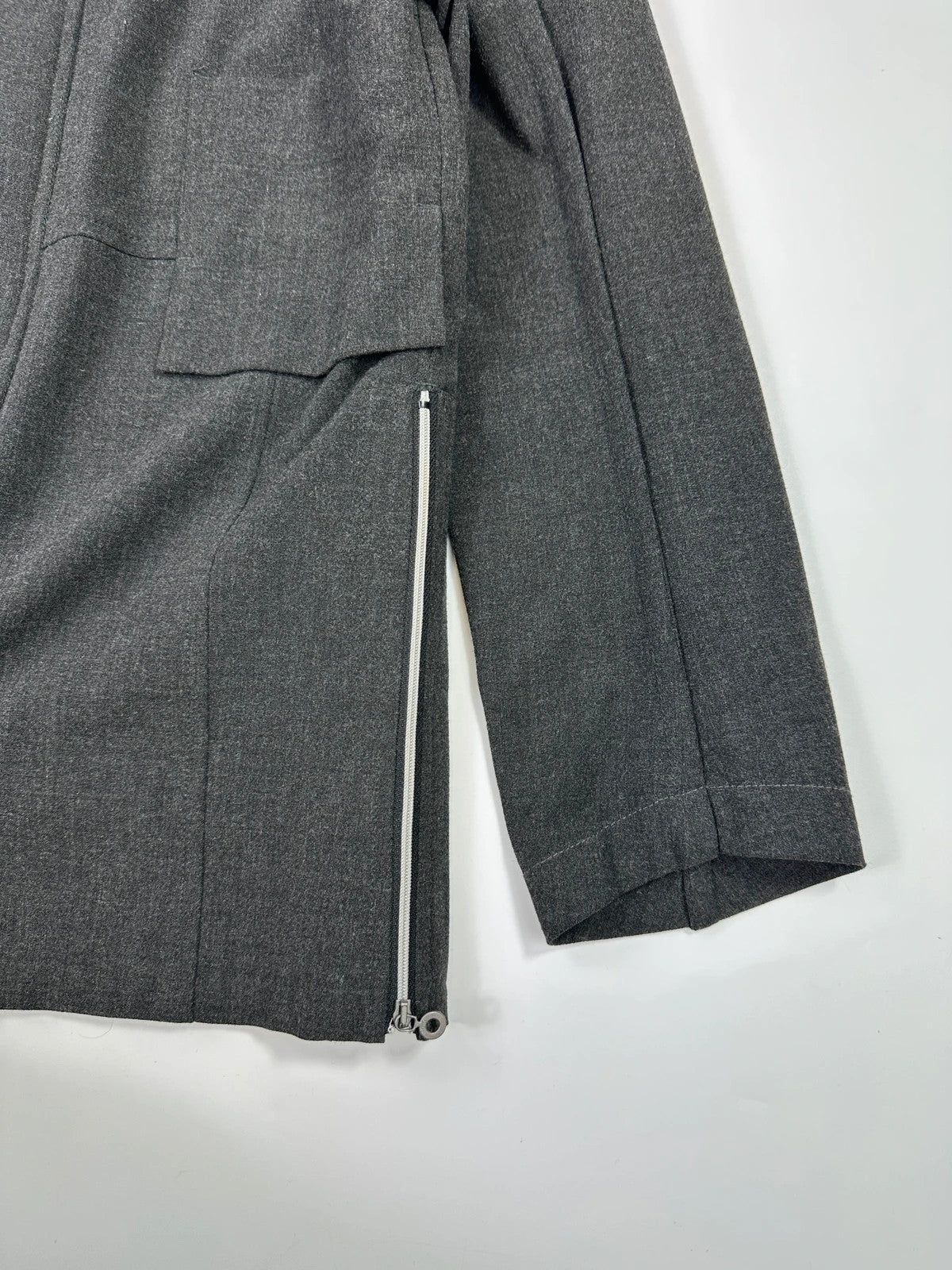 Marithé François Girbaud grey tech jacket with side zippers and minimalist design.