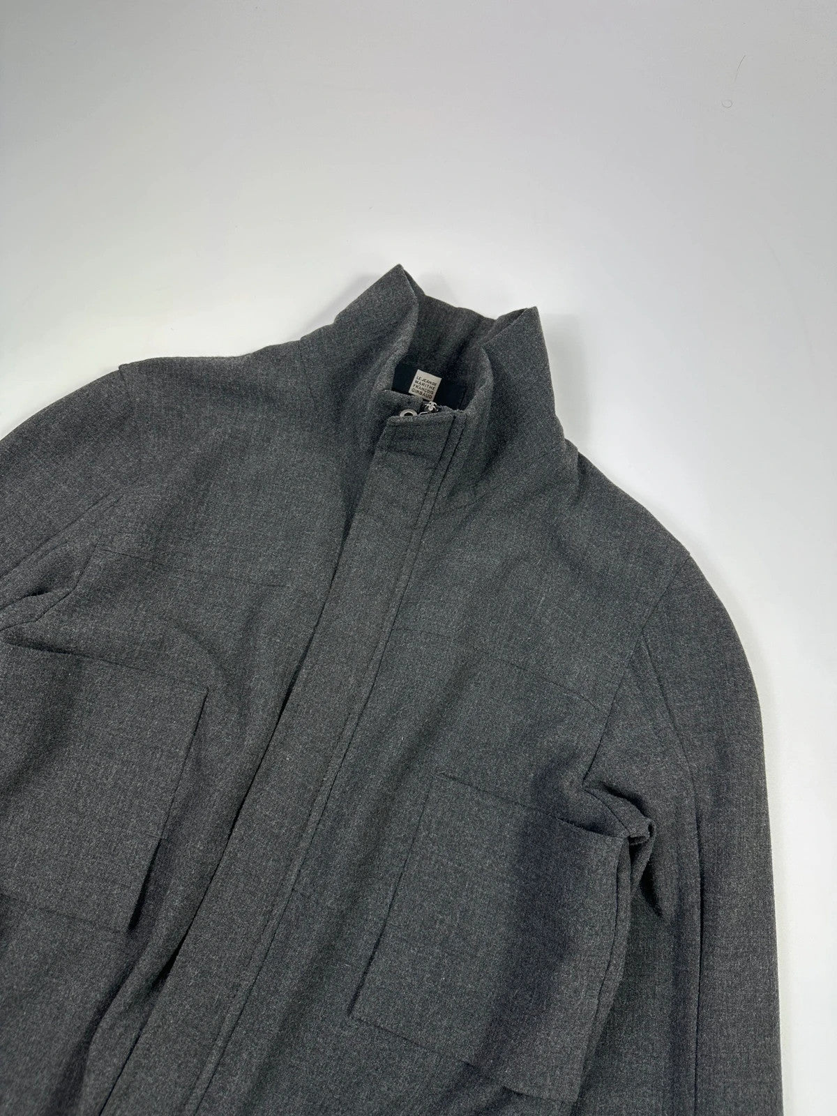 Marithé François Girbaud grey tech jacket with side zippers and minimalist design.
