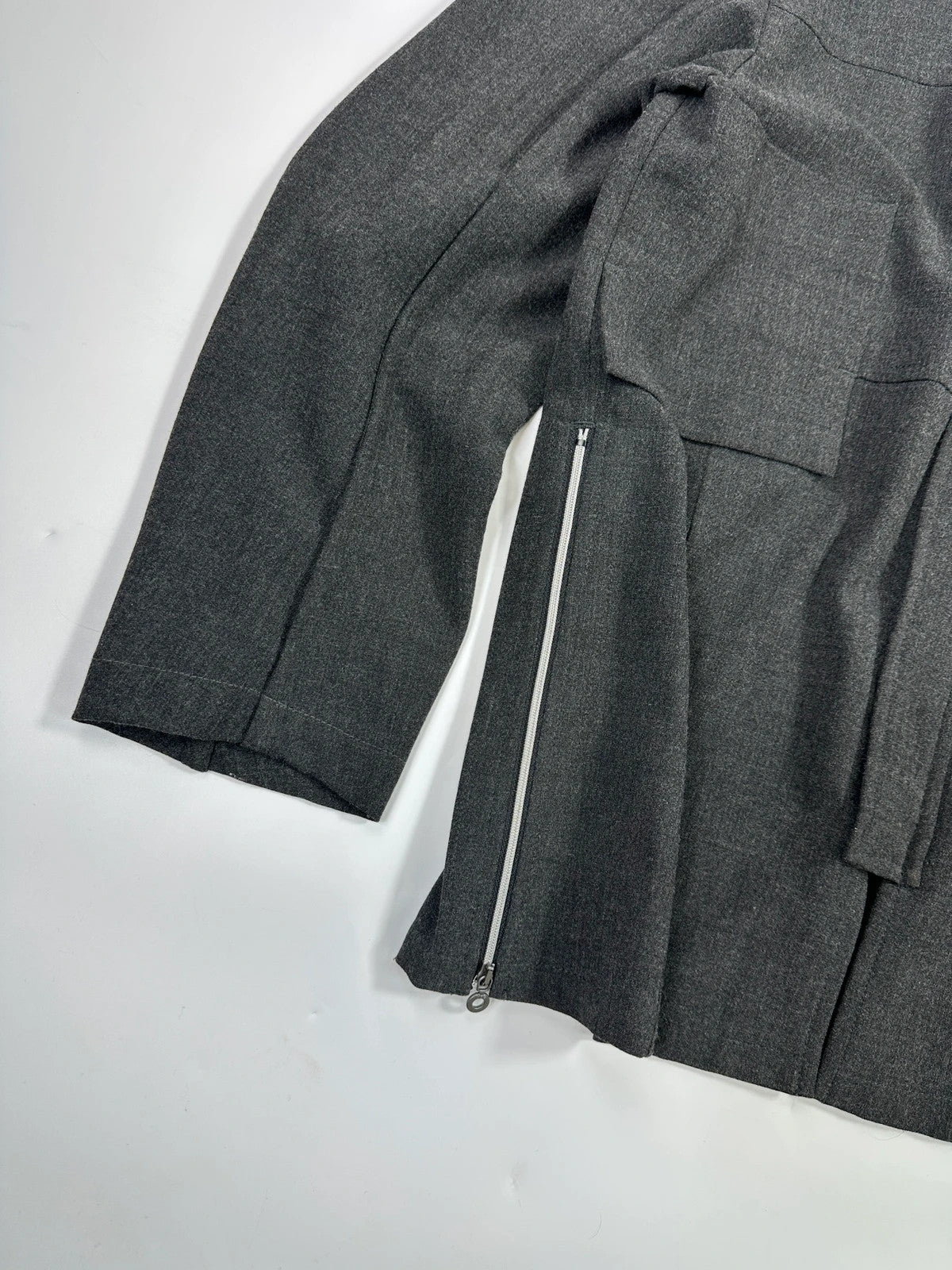 Marithé François Girbaud grey tech jacket with side zippers and minimalist design.