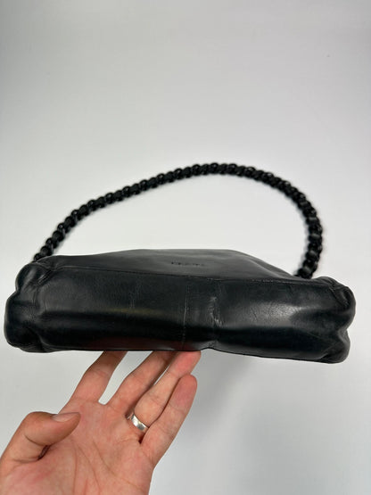 Prada black leather shoulder bag with chain straps from SS99 collection.