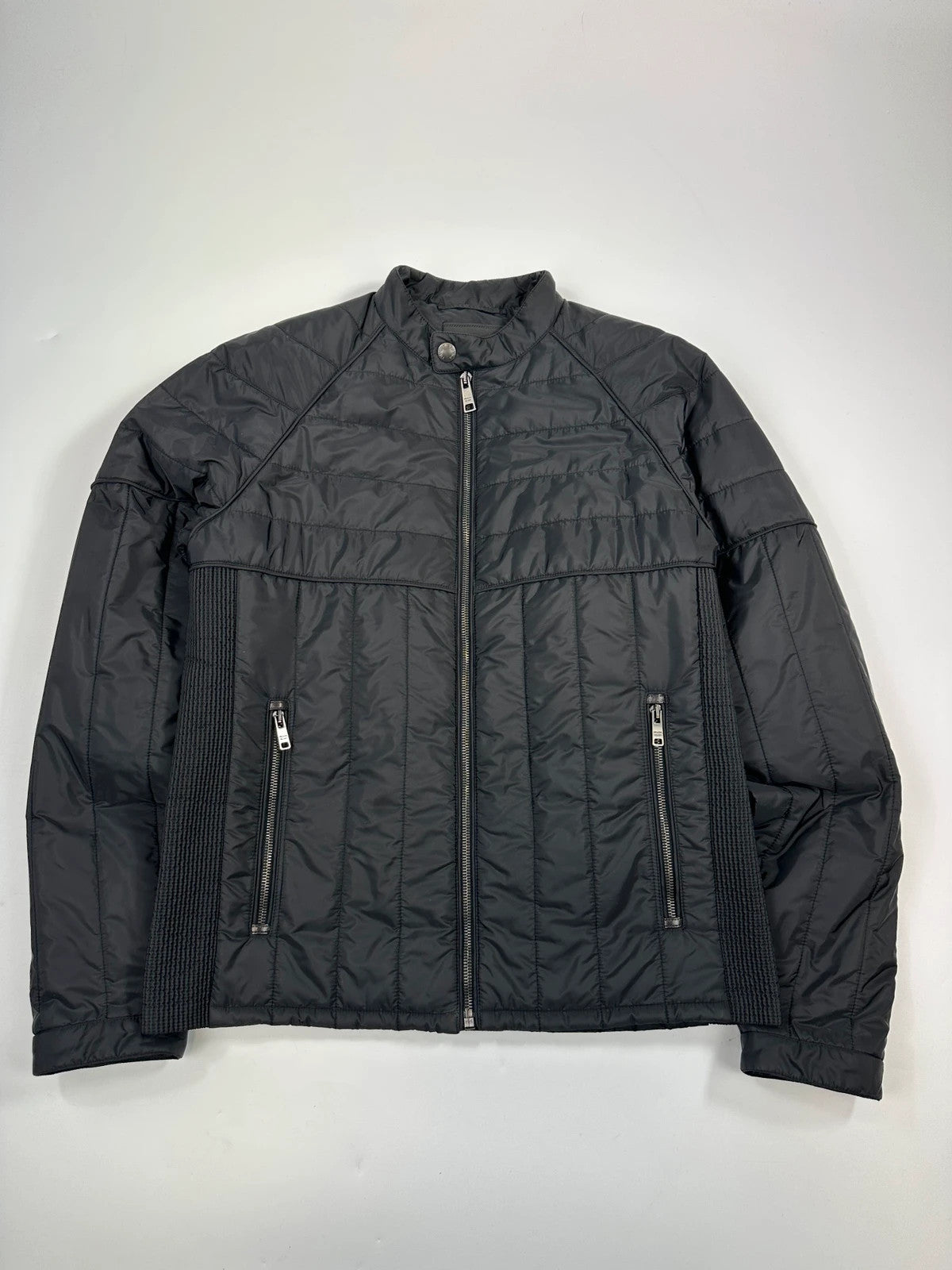 Prada black padded quilted nylon jacket with ribbed side panels and logo detailing.