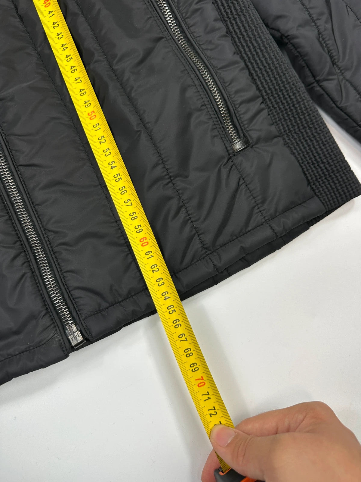 Prada black padded quilted nylon jacket with ribbed side panels and logo detailing.