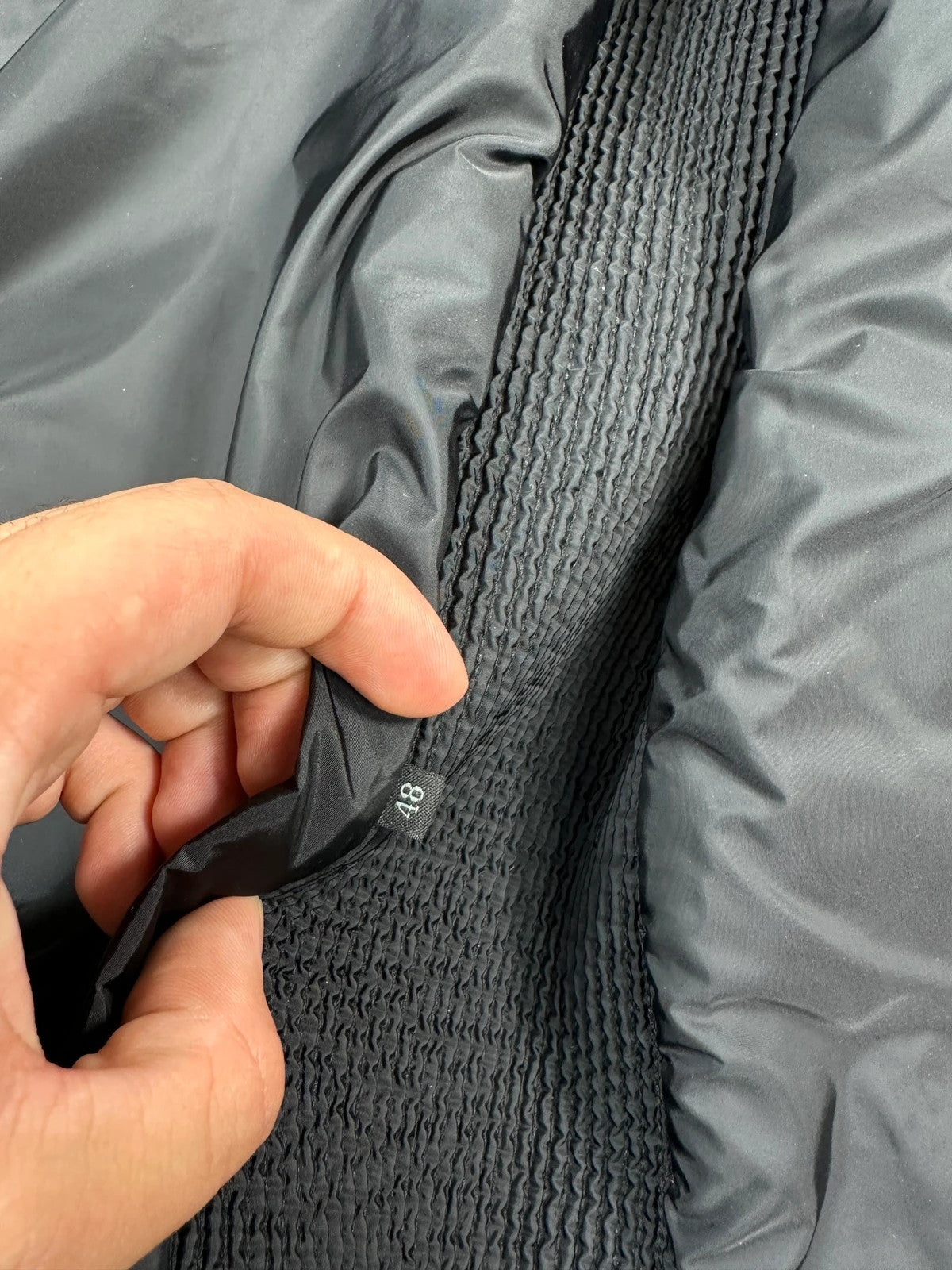 Prada black padded quilted nylon jacket with ribbed side panels and logo detailing.