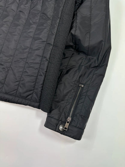 Prada black padded quilted nylon jacket with ribbed side panels and logo detailing.