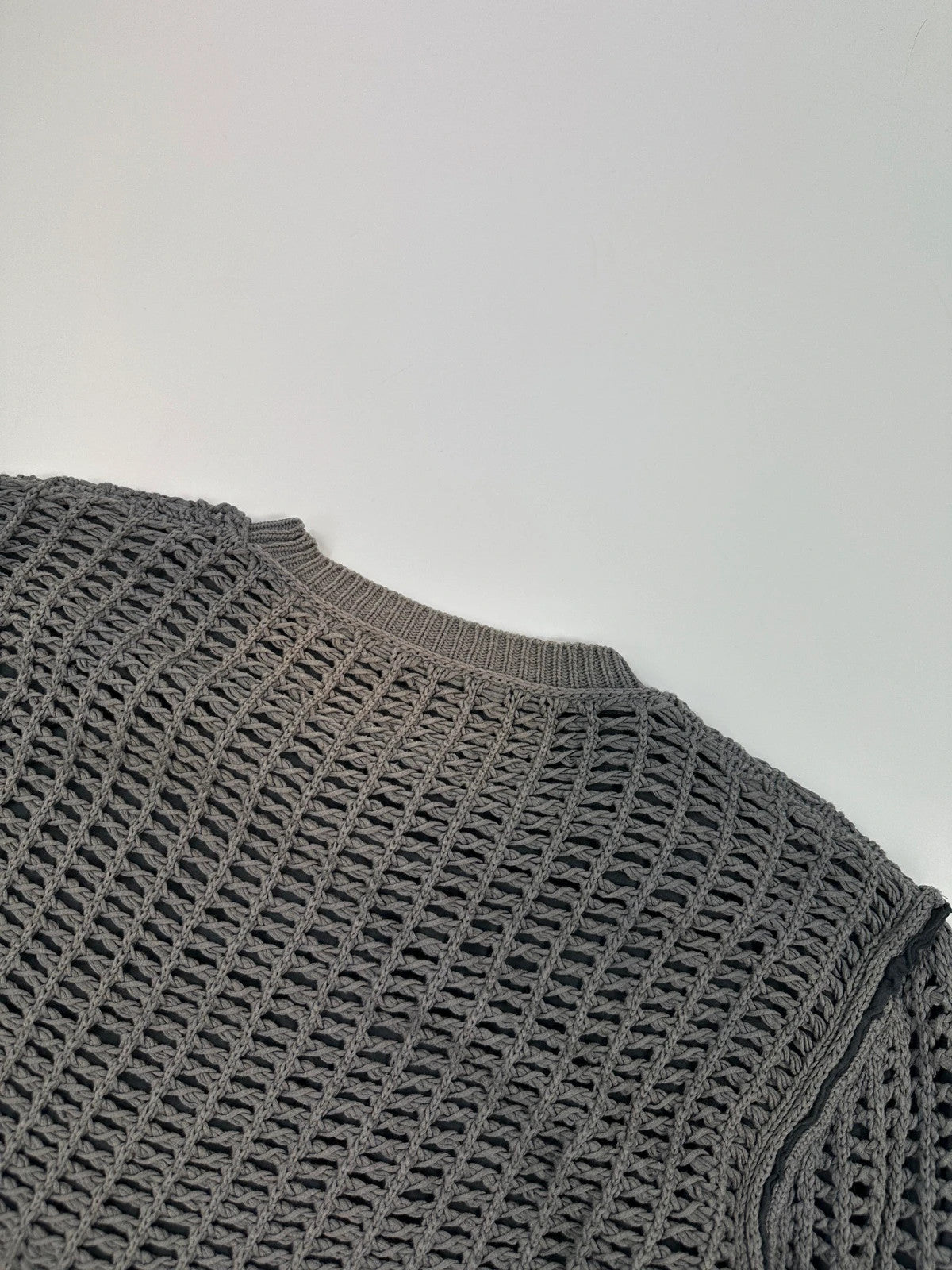 Dolce & Gabbana grey and black mesh knit sweater with layered t-shirt design.