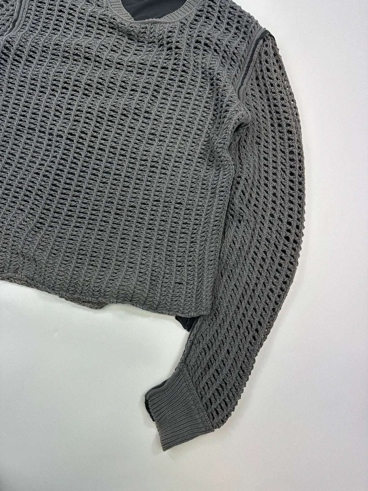 Dolce & Gabbana grey and black mesh knit sweater with layered t-shirt design.