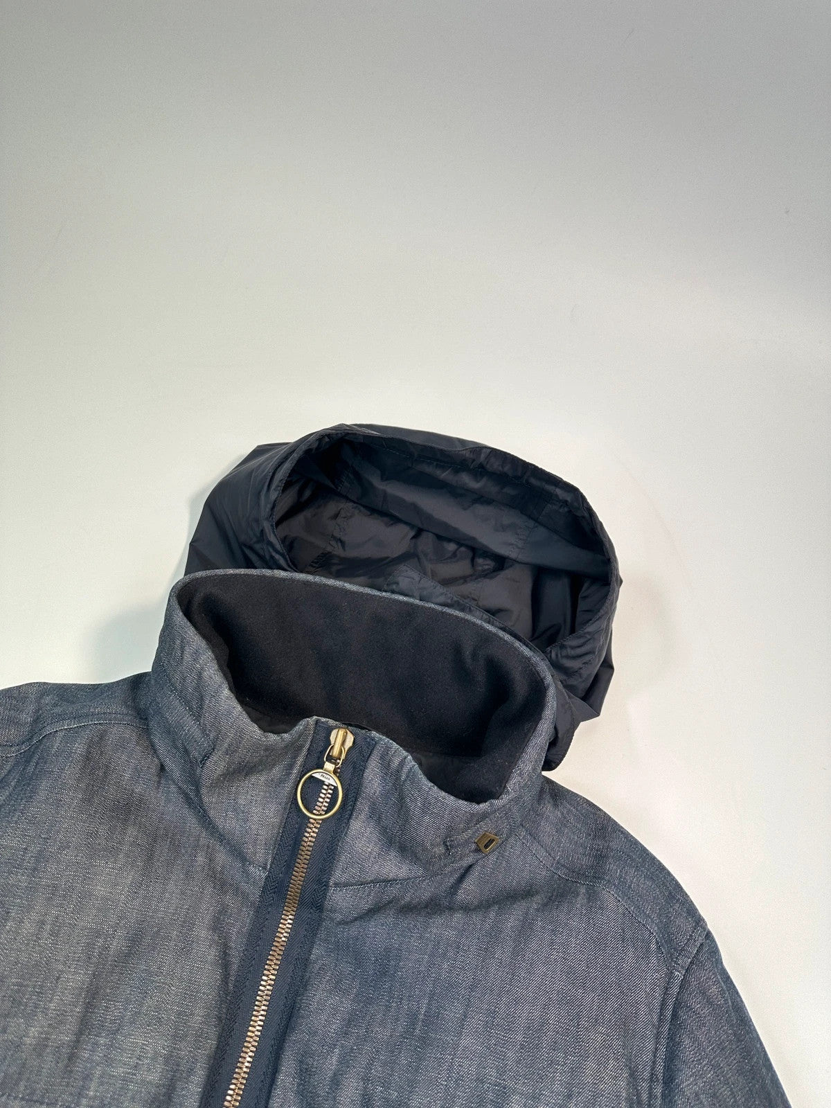Prada blue hybrid down puffer jacket with removable hood and denim material.