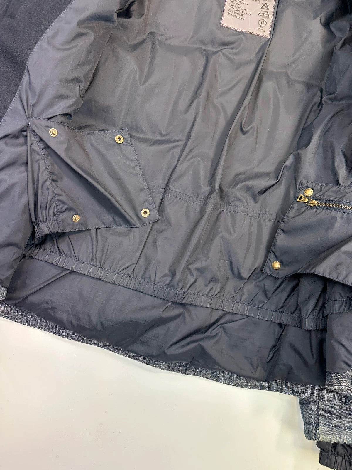 Prada blue hybrid down puffer jacket with removable hood and denim material.