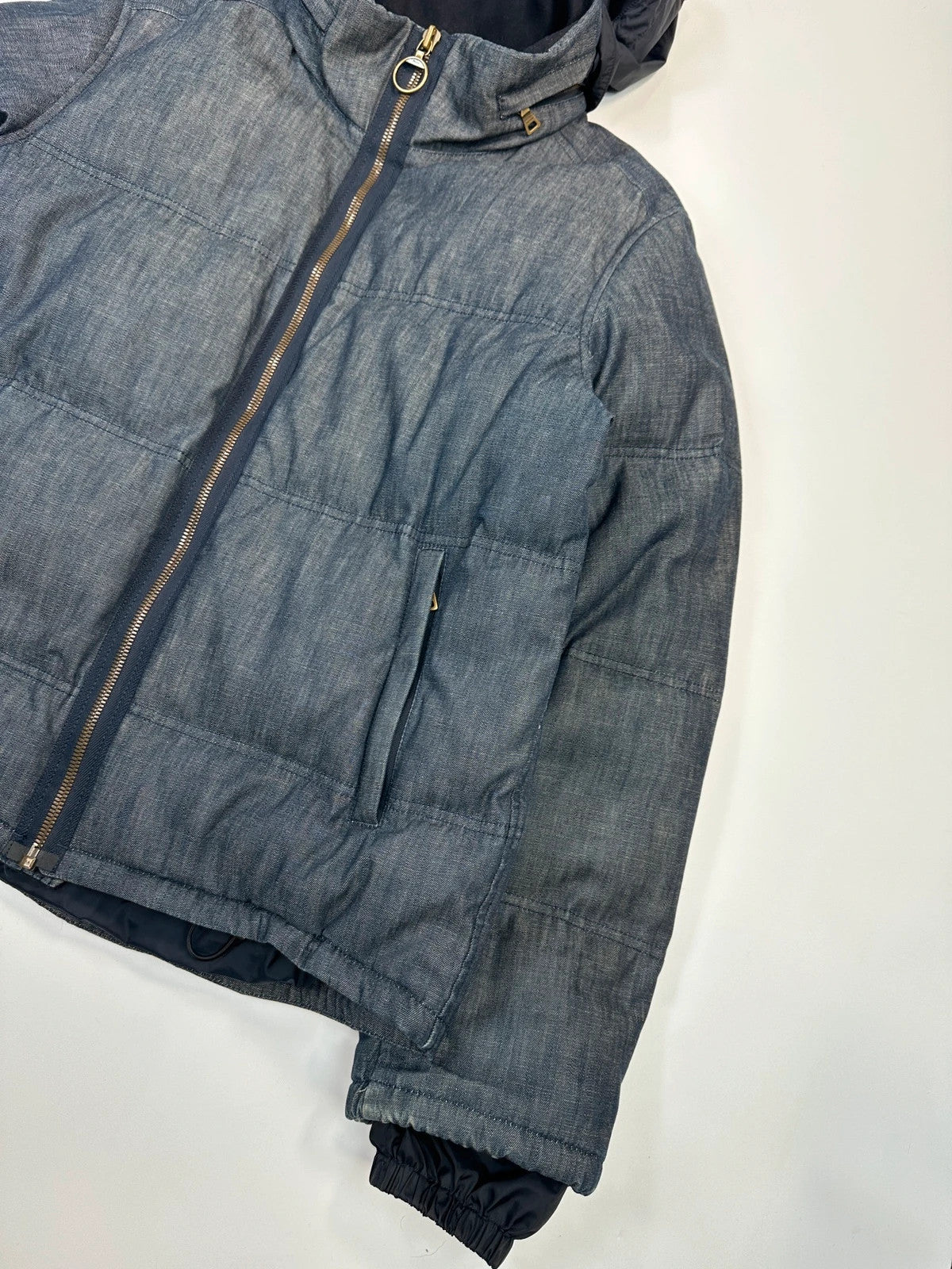 Prada blue hybrid down puffer jacket with removable hood and denim material.