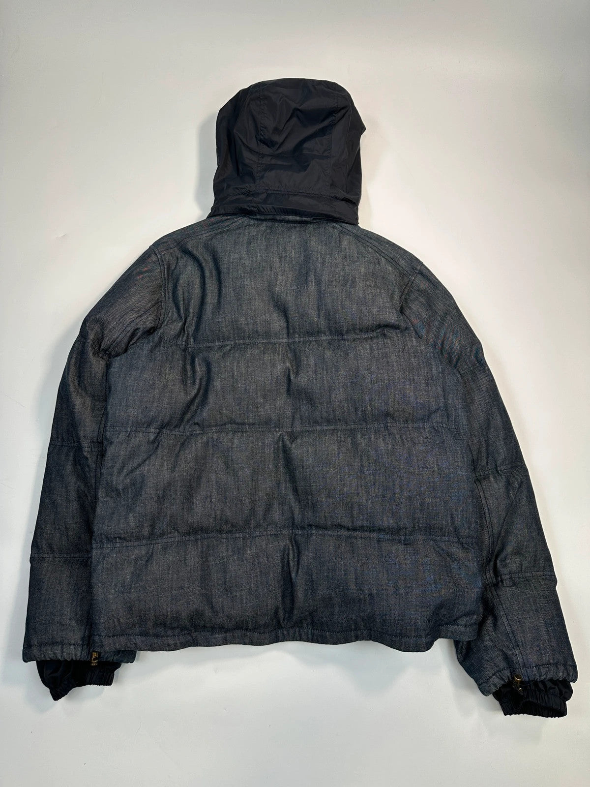 Prada blue hybrid down puffer jacket with removable hood and denim material.
