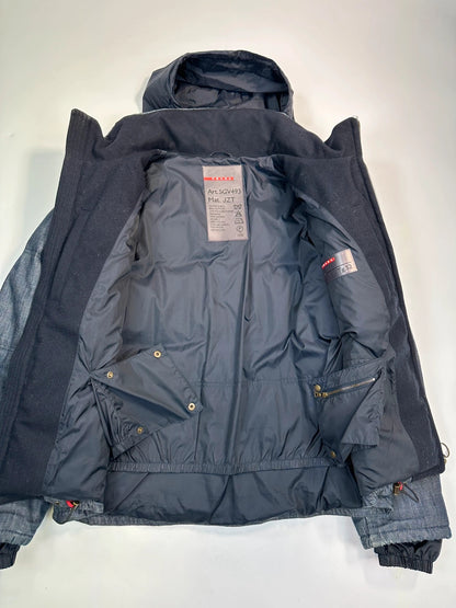 Prada blue hybrid down puffer jacket with removable hood and denim material.