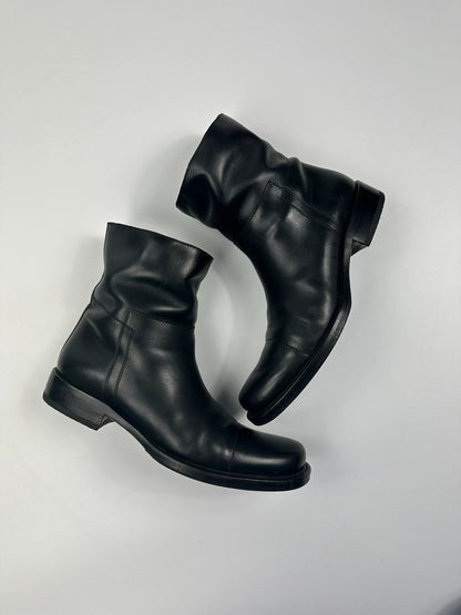 Prada black leather ankle boots with round toe and subtle logo detailing.