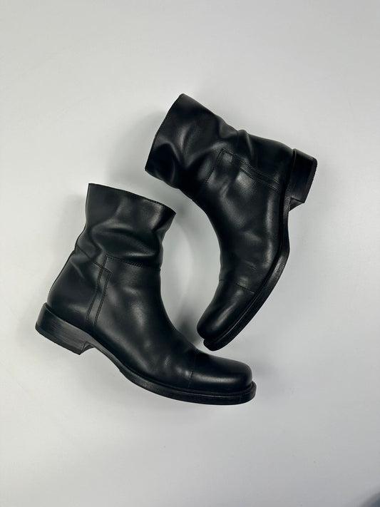 Prada black leather ankle boots with round toe and subtle logo detailing.