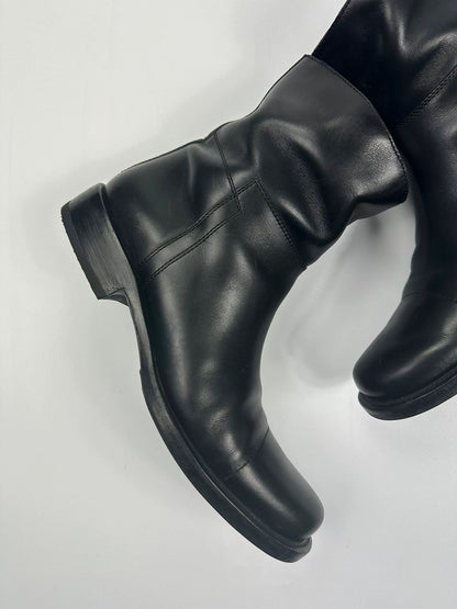 Prada black leather ankle boots with round toe and subtle logo detailing.