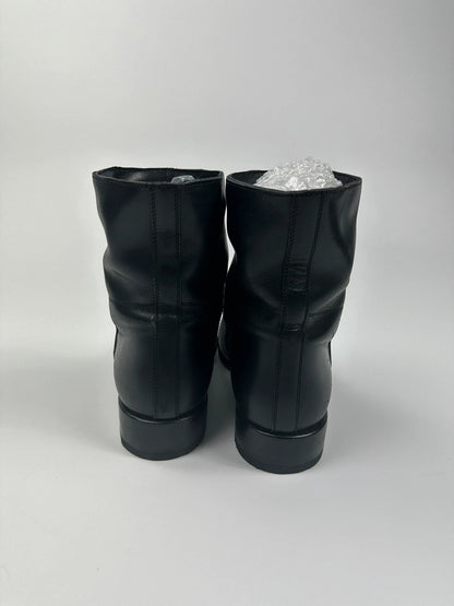Prada black leather ankle boots with round toe and subtle logo detailing.