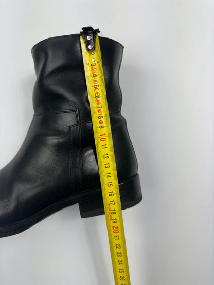 Prada black leather ankle boots with round toe and subtle logo detailing.